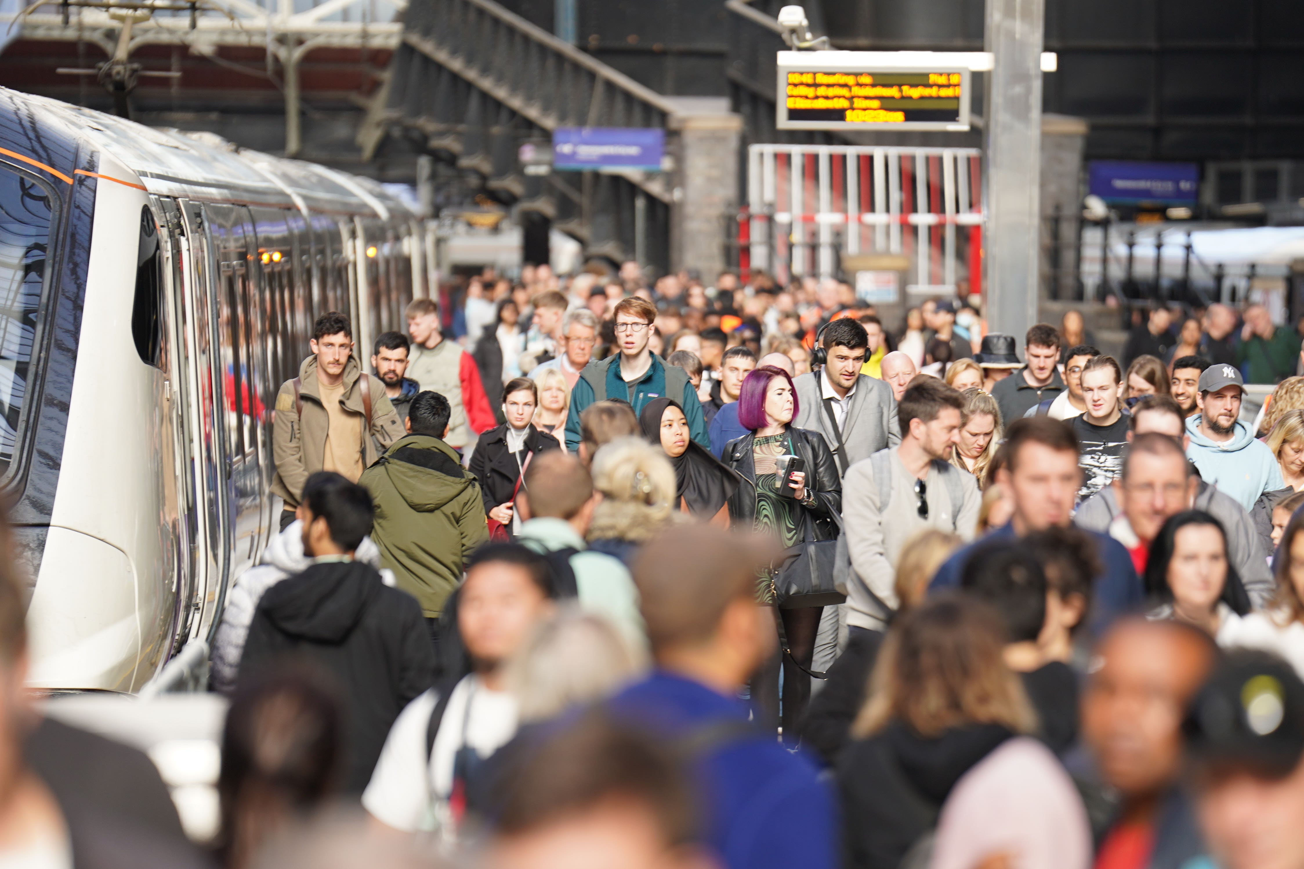 Passengers disembark a train at Paddington (James Manning/PA)