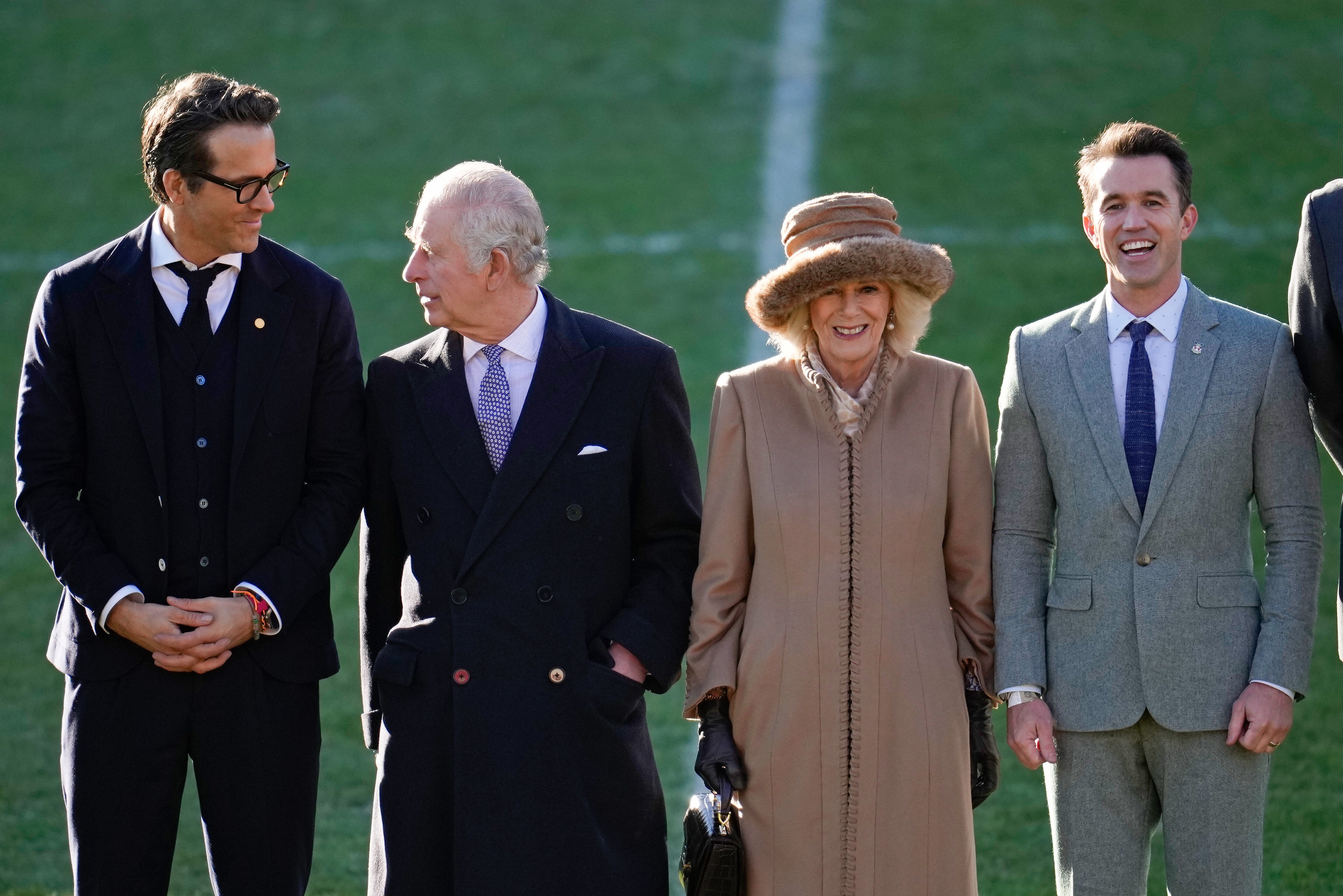 King Charles III and Camilla, Queen Consort talk to Co-Owners Wrexham AFC Ryan Reynolds (L) and Rob McElhenney (R) during their visit to Wrexham AFC on December 09, 2022