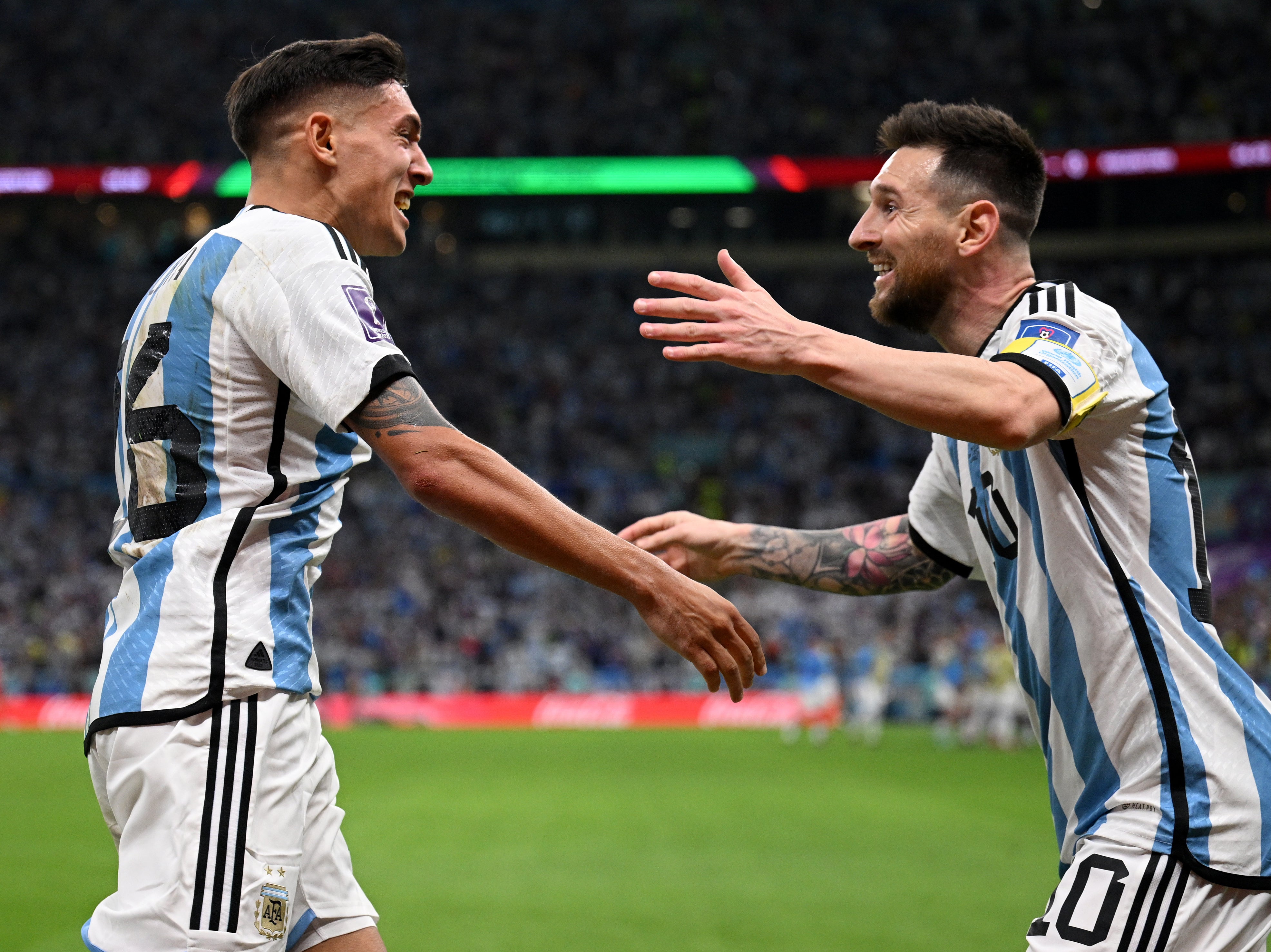 Nahuel Molina (left) celebrates his goal with Lionel Messi, who provided the assist