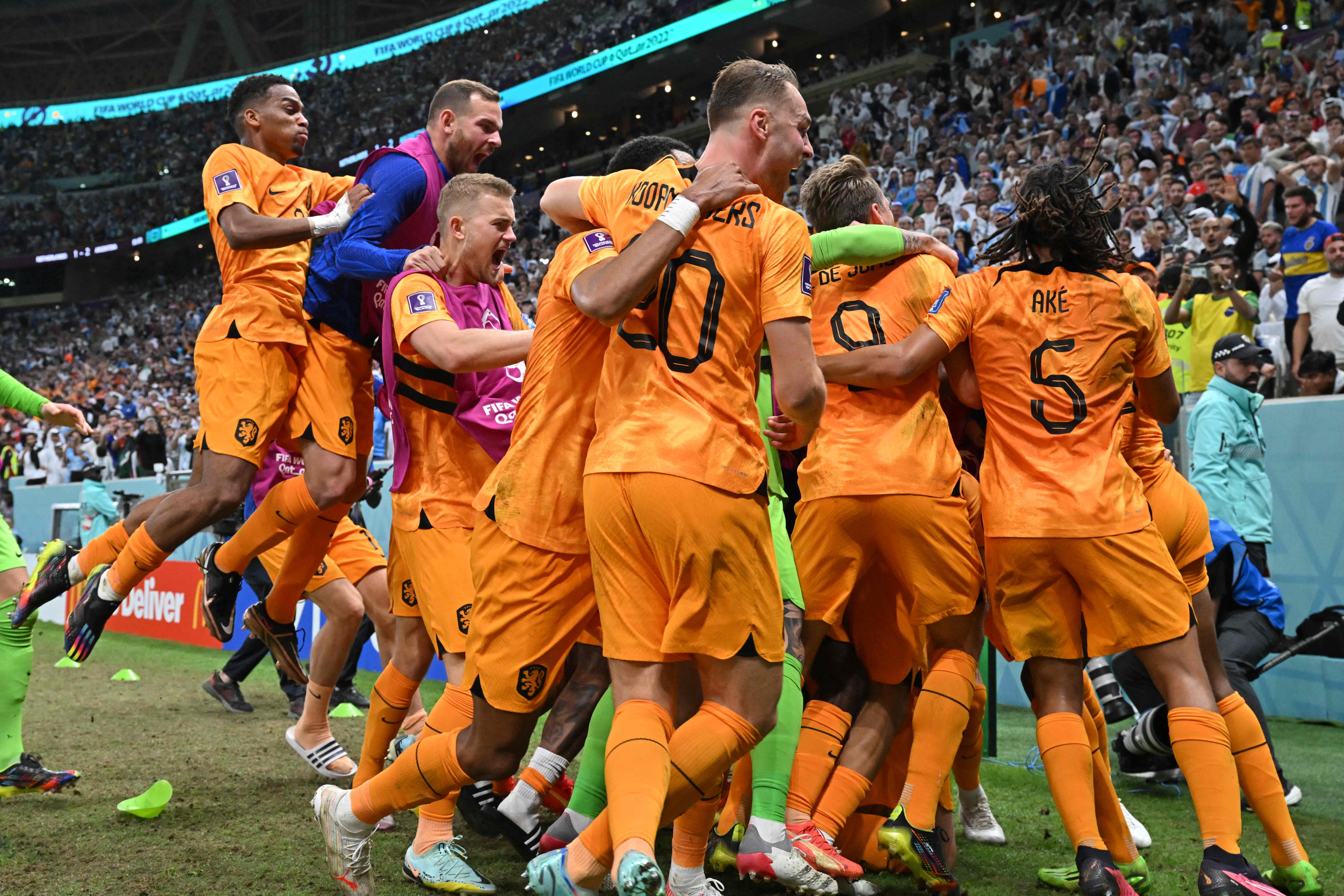 Netherlands’ forward Wout Weghorst celebrates with teammates