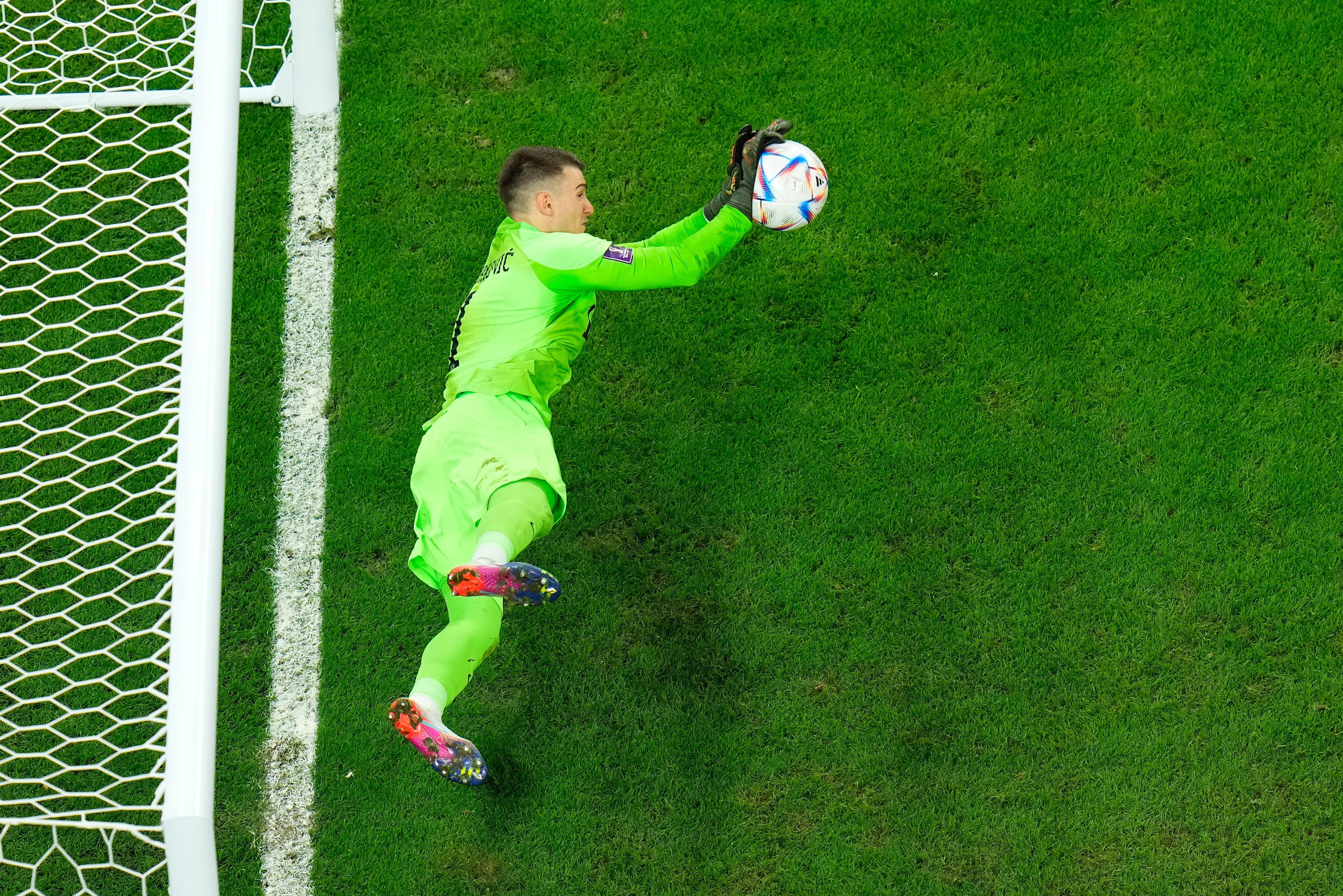 Dominik Livakovic saving a penalty in Croatia’s shootout win over Brazil