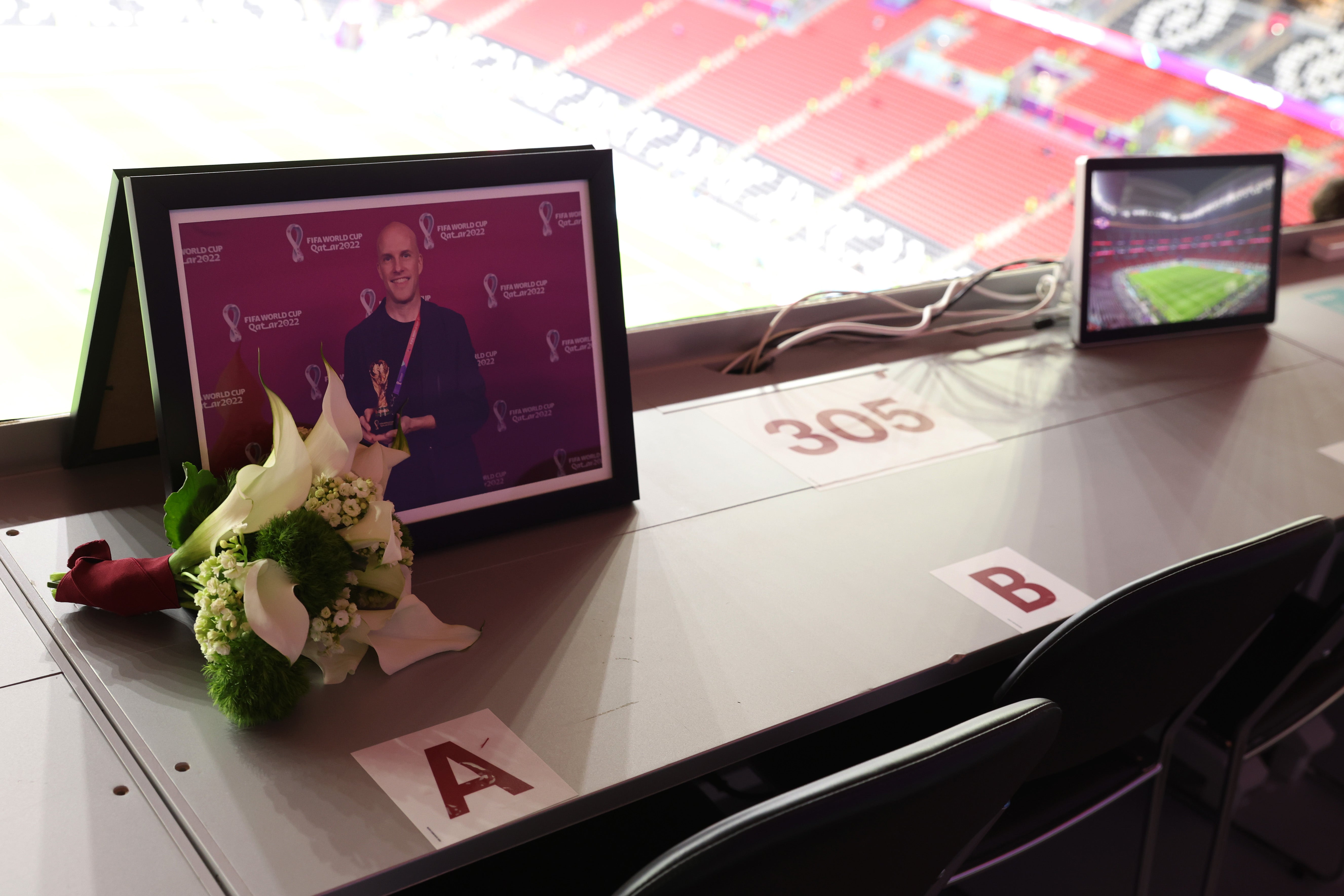 Flowers are placed in memory of Grant Wahl, an American sports journalist who passed away whilst reporting on the Argentina and Netherlands match