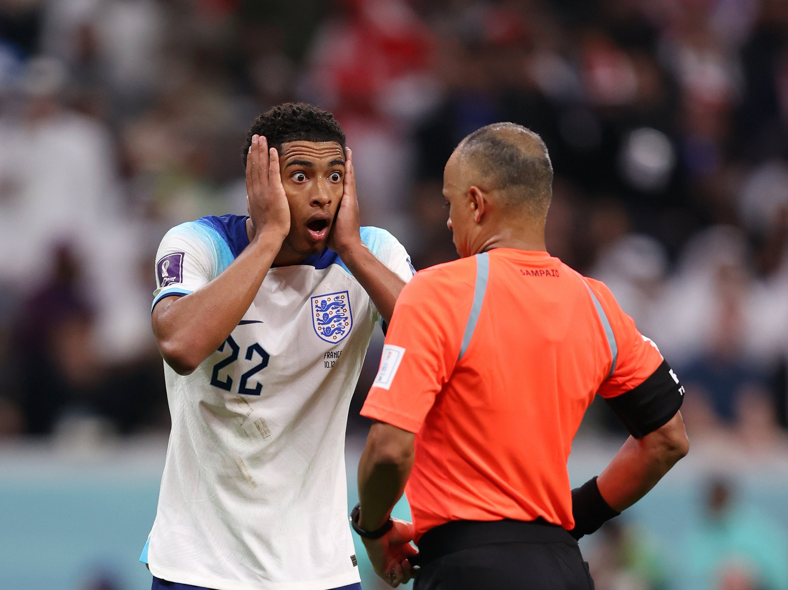 Jude Bellingham of England speaks to referee Wilton Pereira Sampaio