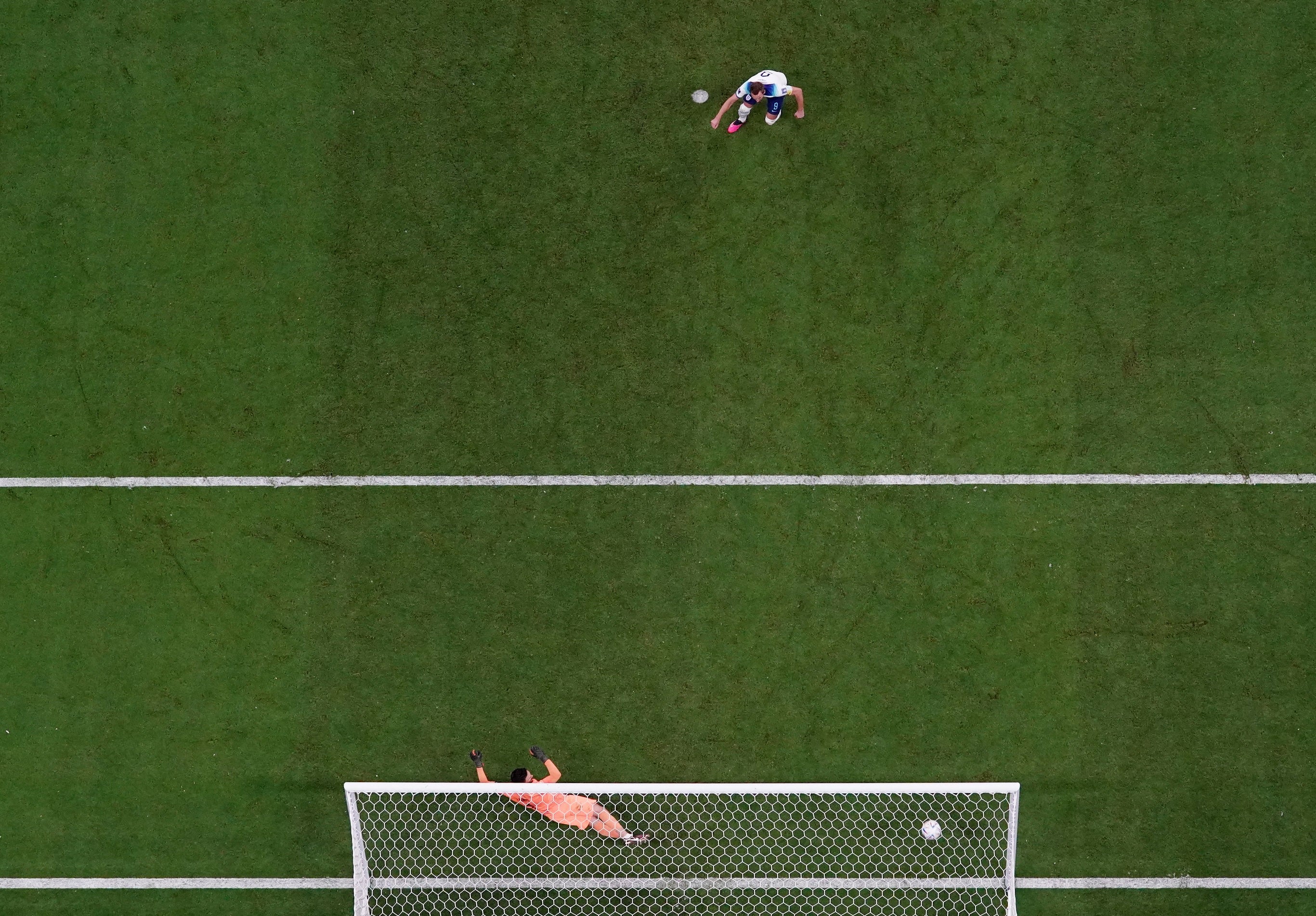 Harry Kane scores their first goal from the penalty spot past France's Hugo Lloris