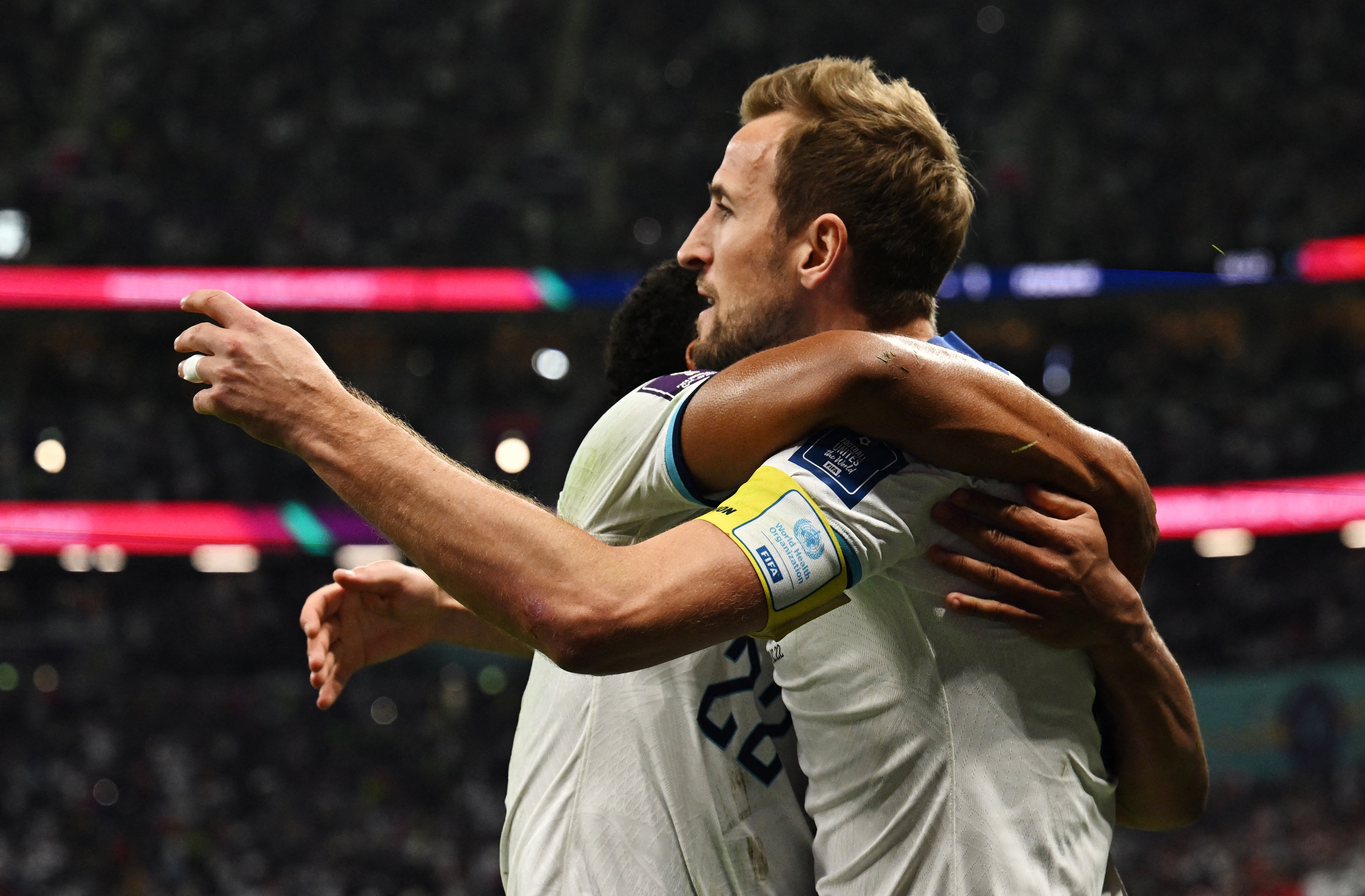 Harry Kane celebrates scoring their first goal with Jude Bellingham