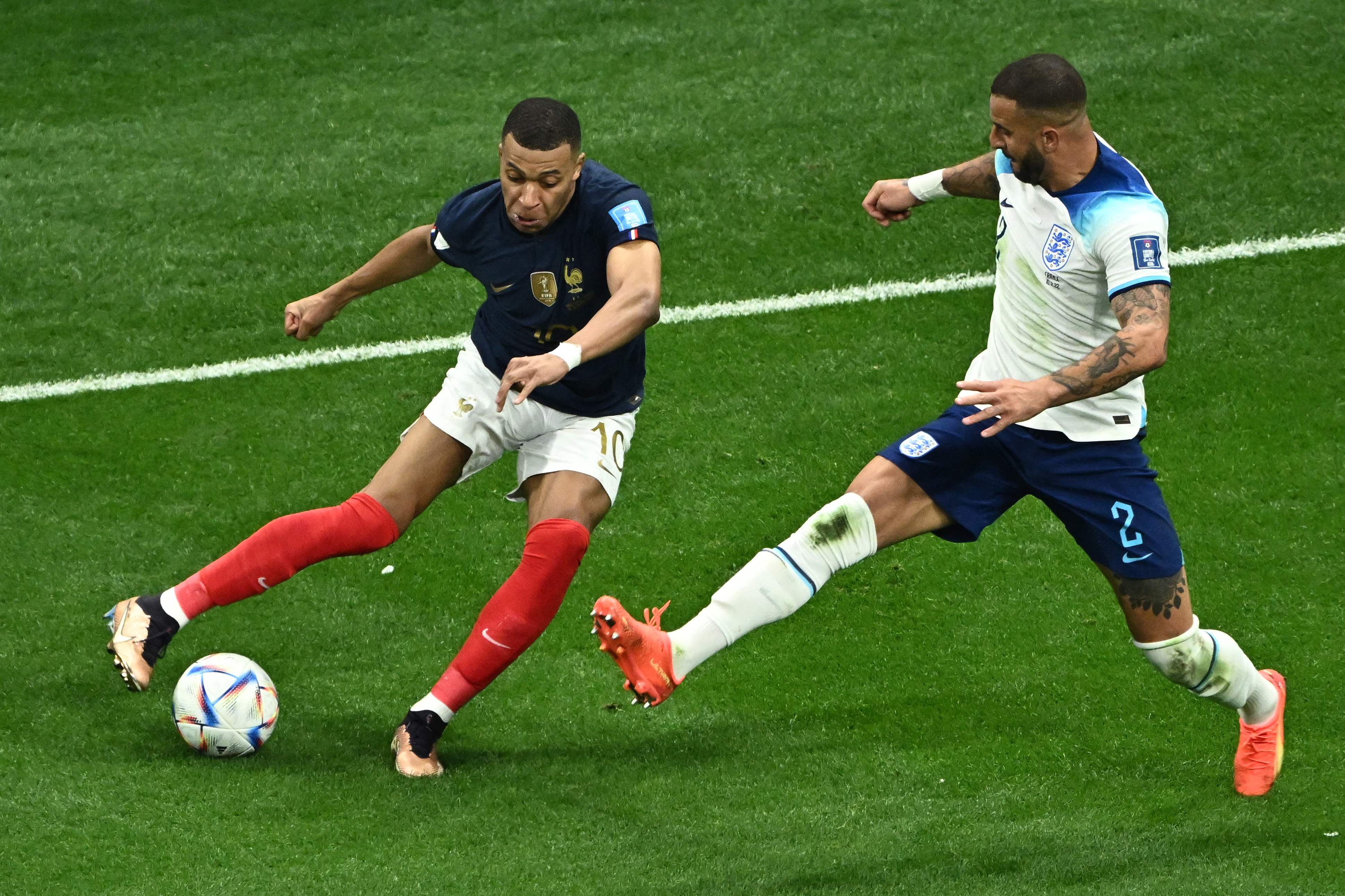 Kylian Mbappe is marked by England's defender #02 Kyle Walker