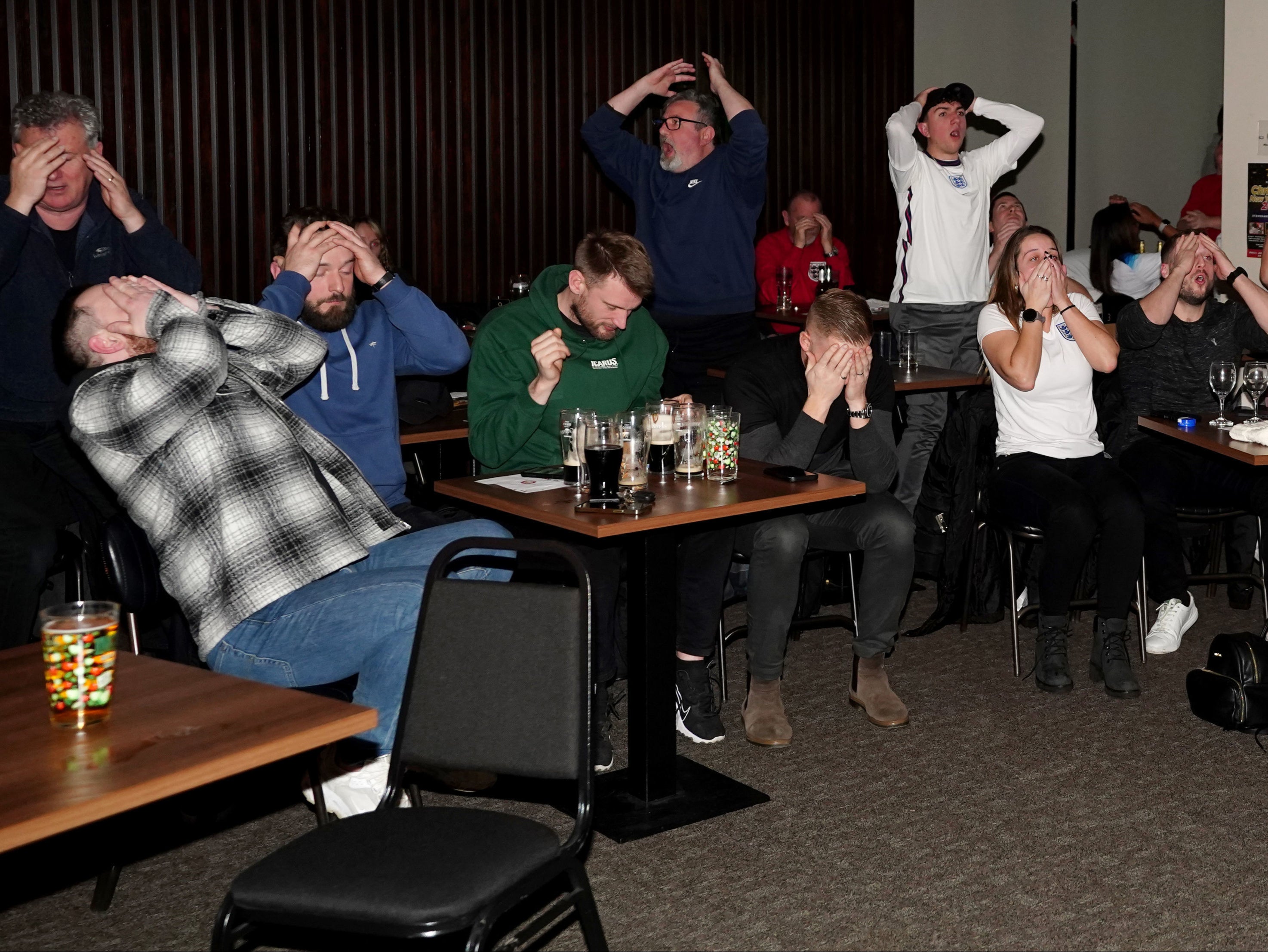 Fans covered their faces after Harry Kane missed a penalty