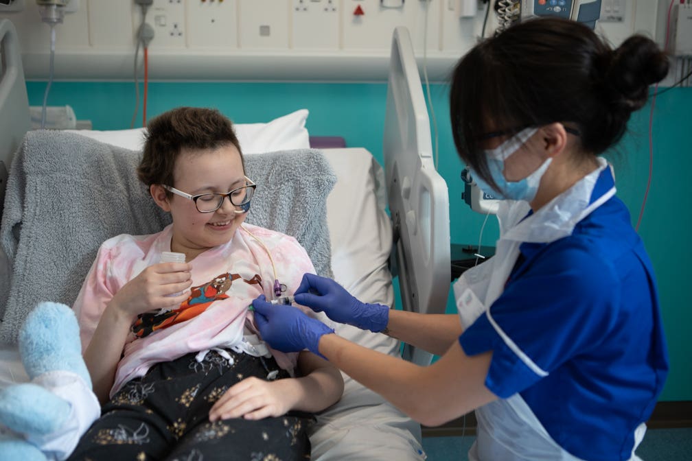 A senior research nurse administers the new therapy to Alyssa