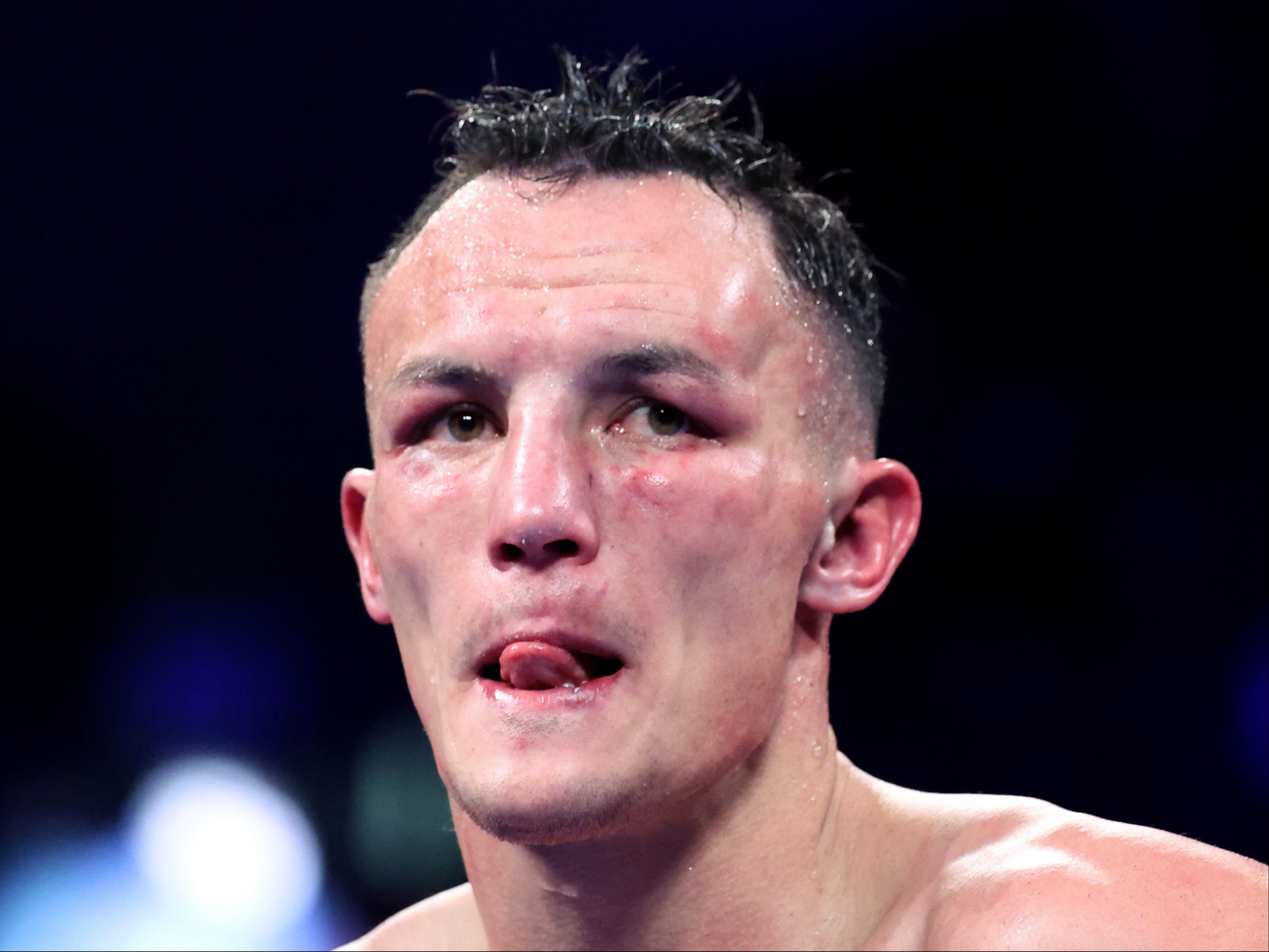 A beaten Josh Warrington reacts as his hometown crowd falls silent in Leeds