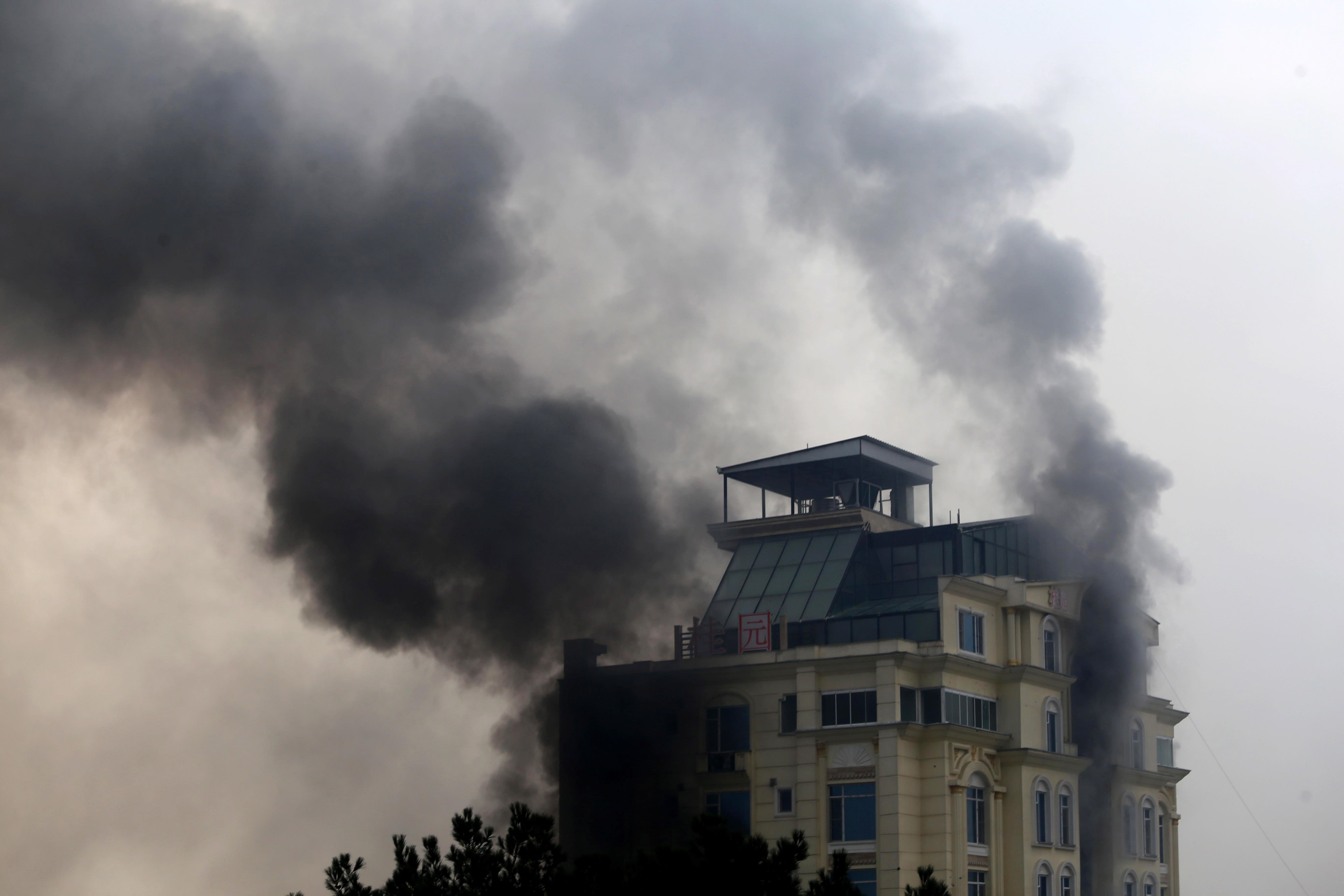 Smoke billows from a hotel after an attack in Kabul