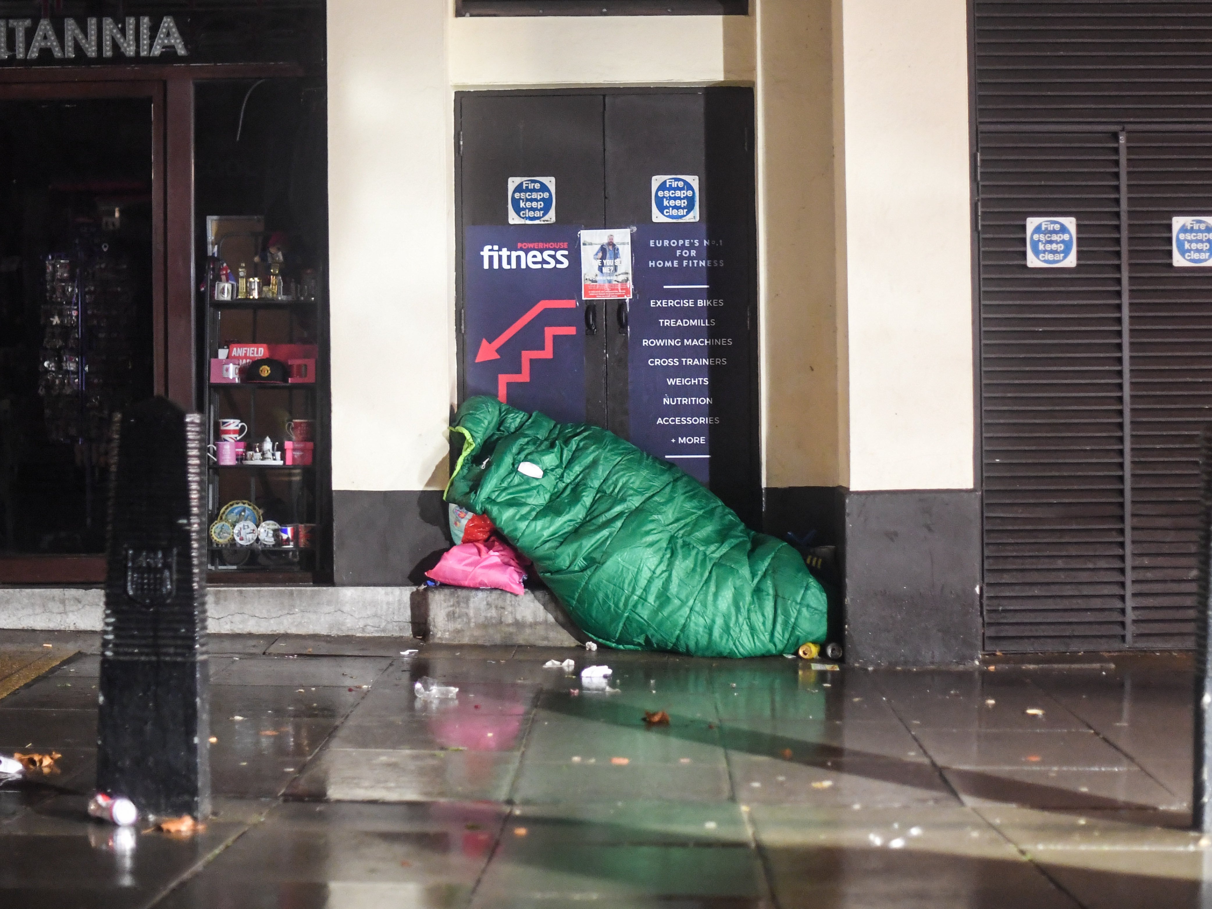 A homeless person sleeping in a doorway in London in 2020