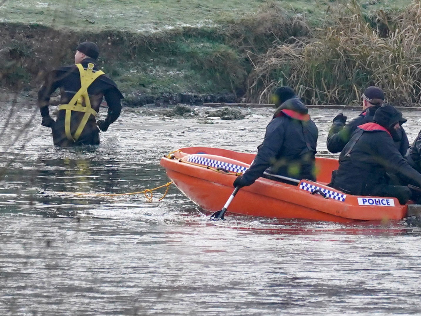 Police break the ice on the lake at Babbs Mill Park in Kingshurst, after the deaths of four boys