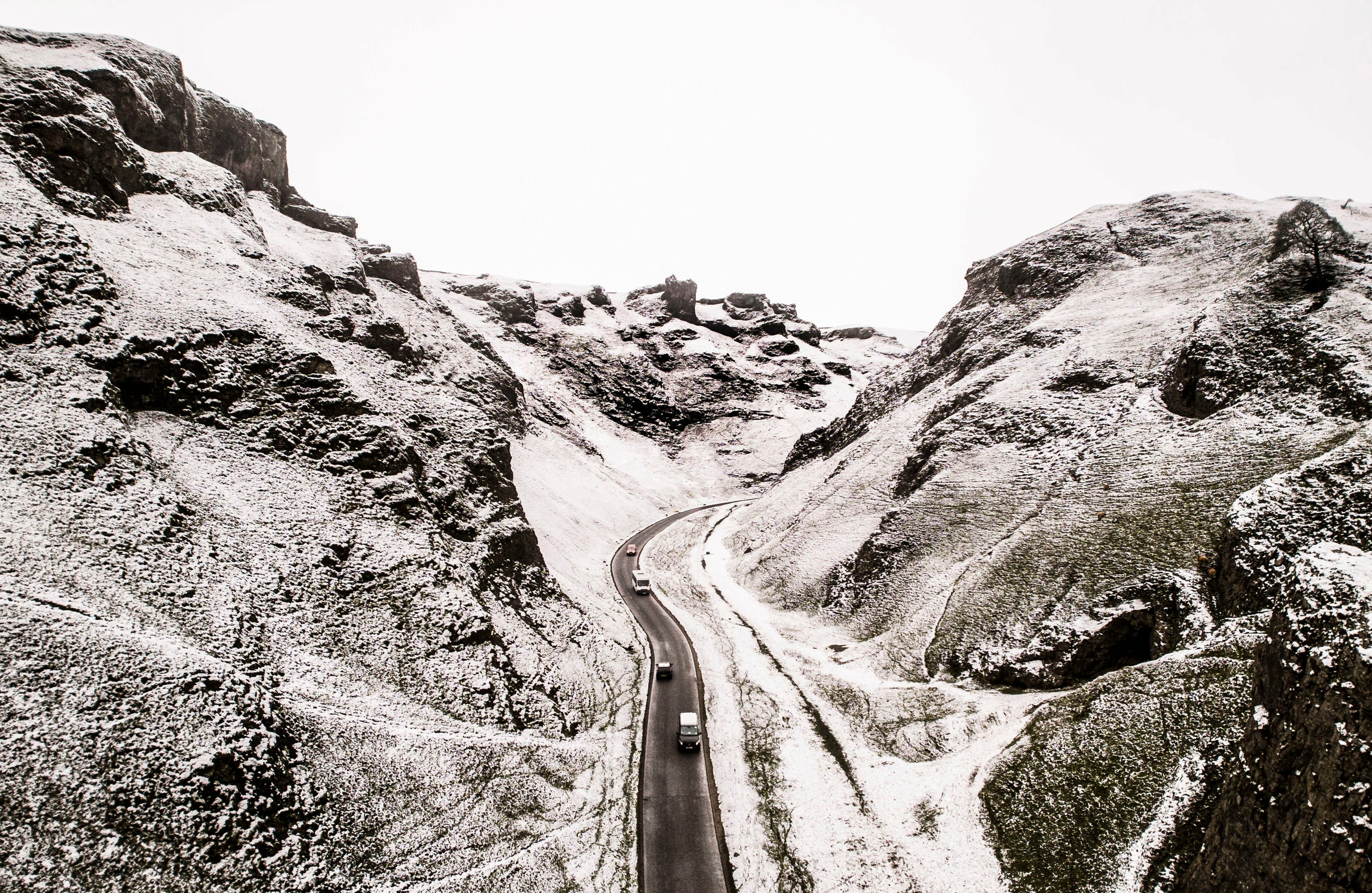 Cars negotiate Winnats Pass in the Peak District as the UK has a snowy week