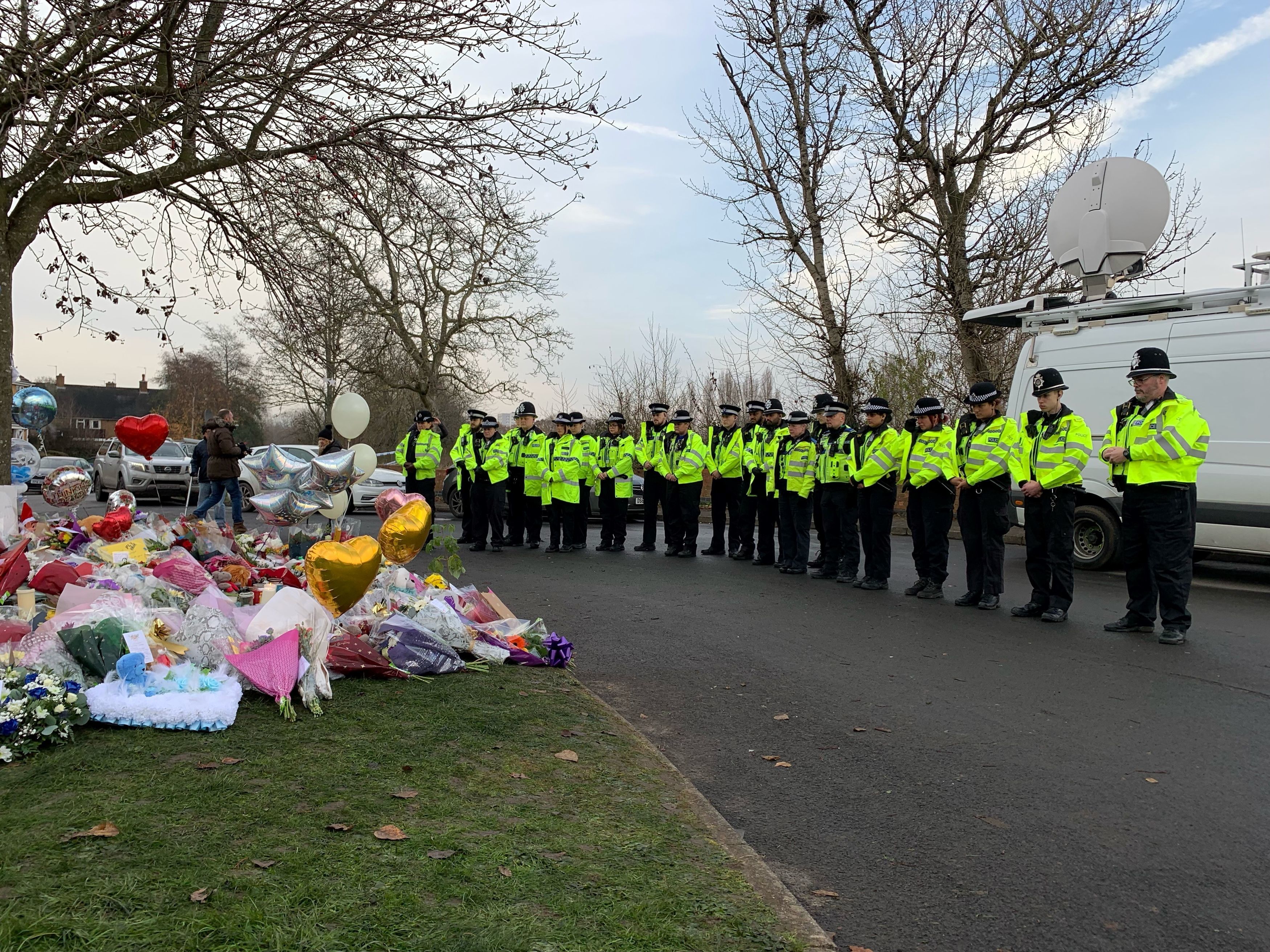 Officers from West Midlands Police lay bouquets of flowers and stood in silence near to the scene in Babbs Mill Park in Kingshurst, Solihull