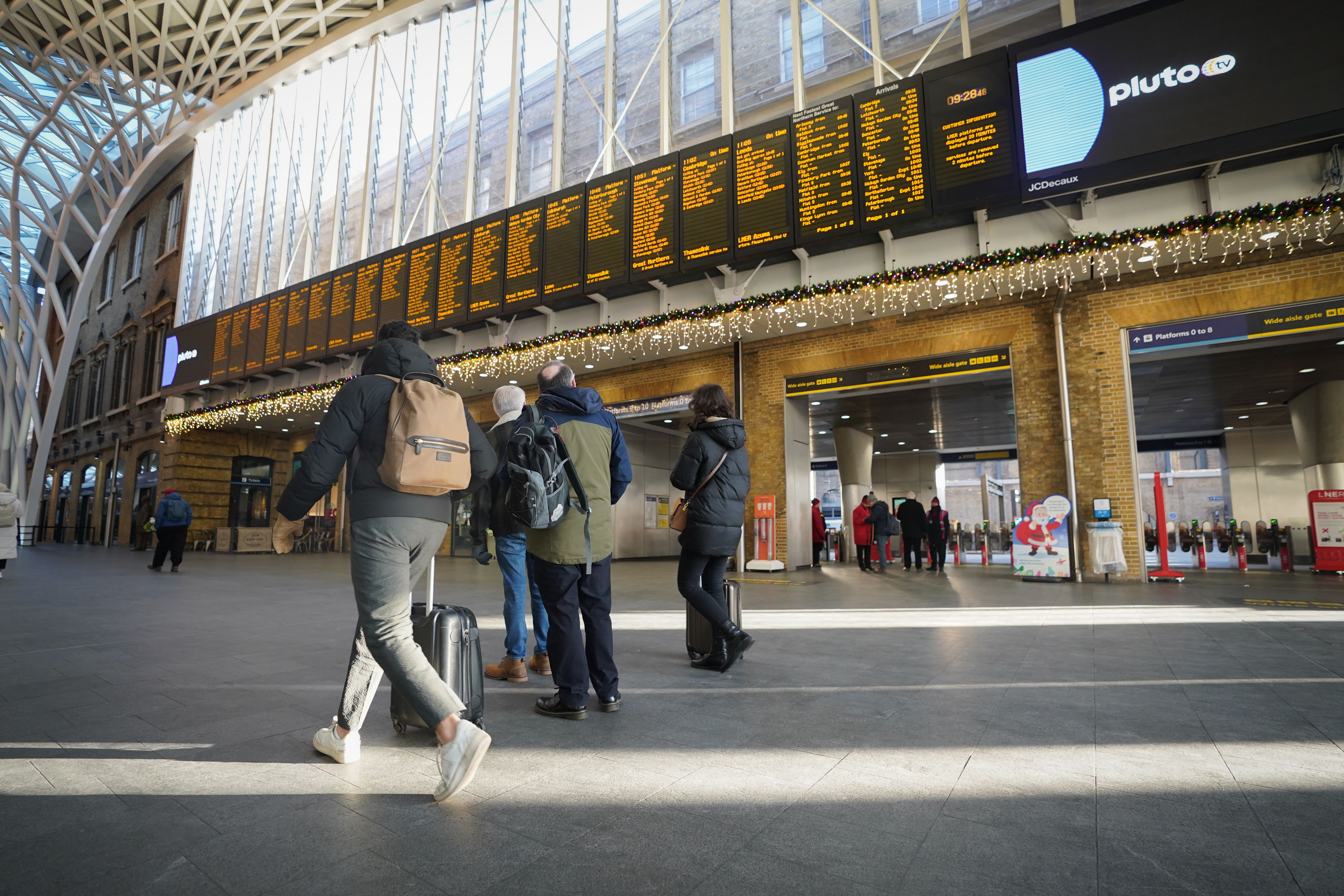 Passengers at King’s Cross station in London during a strike by members of the Rail, Maritime and Transport union (RMT) (James Manning/PA)