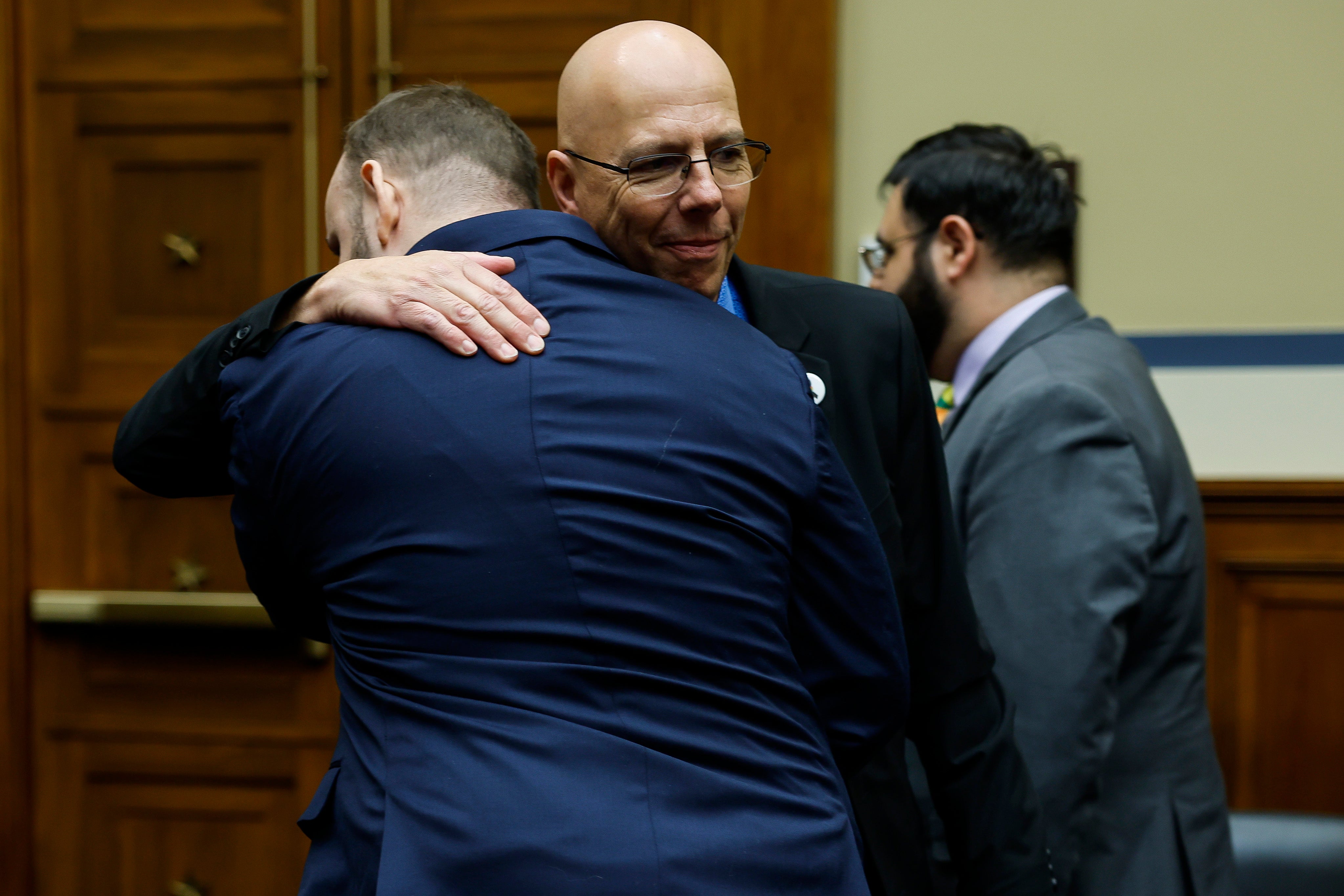 Club Q owner Matthew Haynes, right, embraces mass shooting survivor James Slaugh.