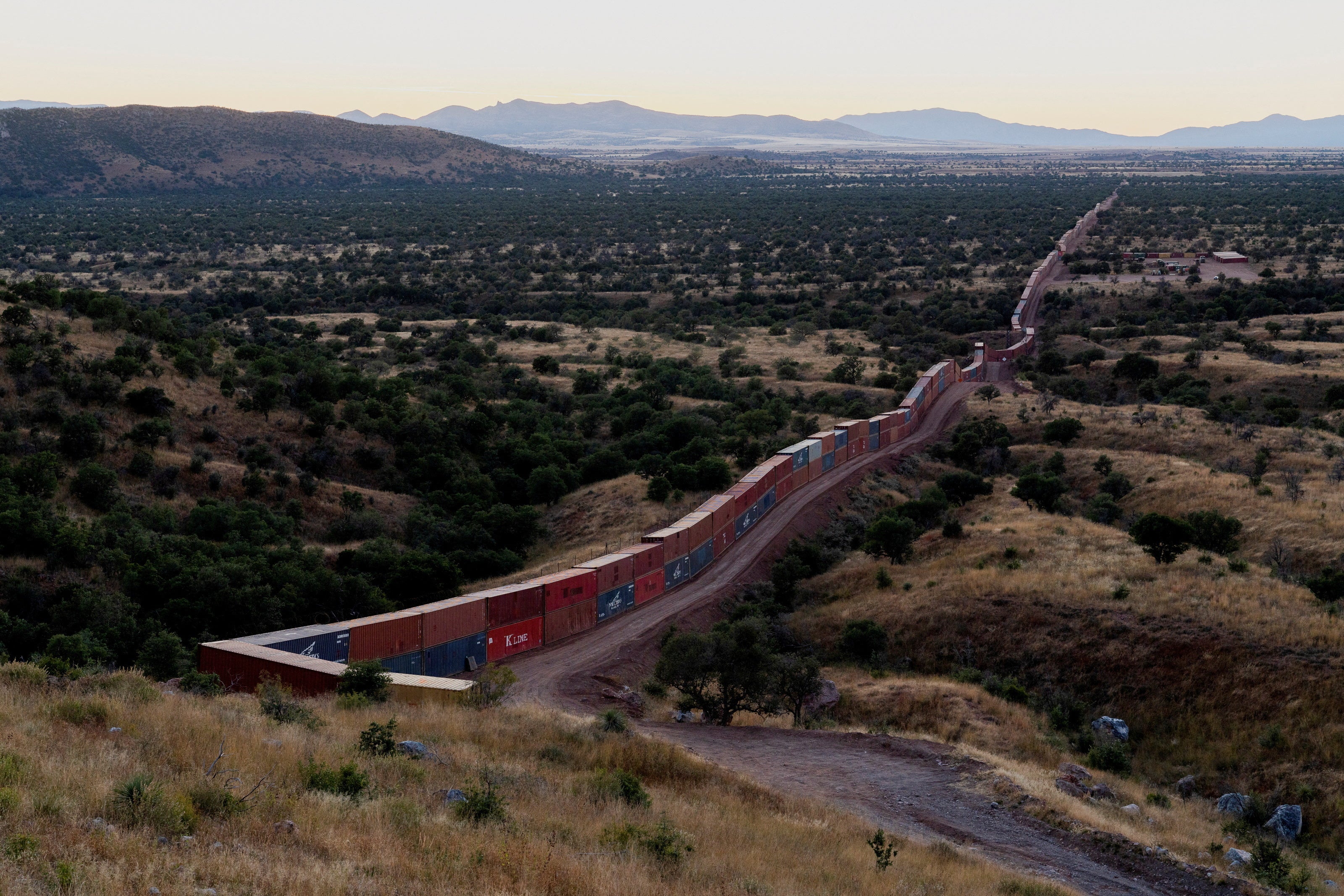 A view of shipping containers from the border wall on the frontier with Mexico in Cochise County, Arizona