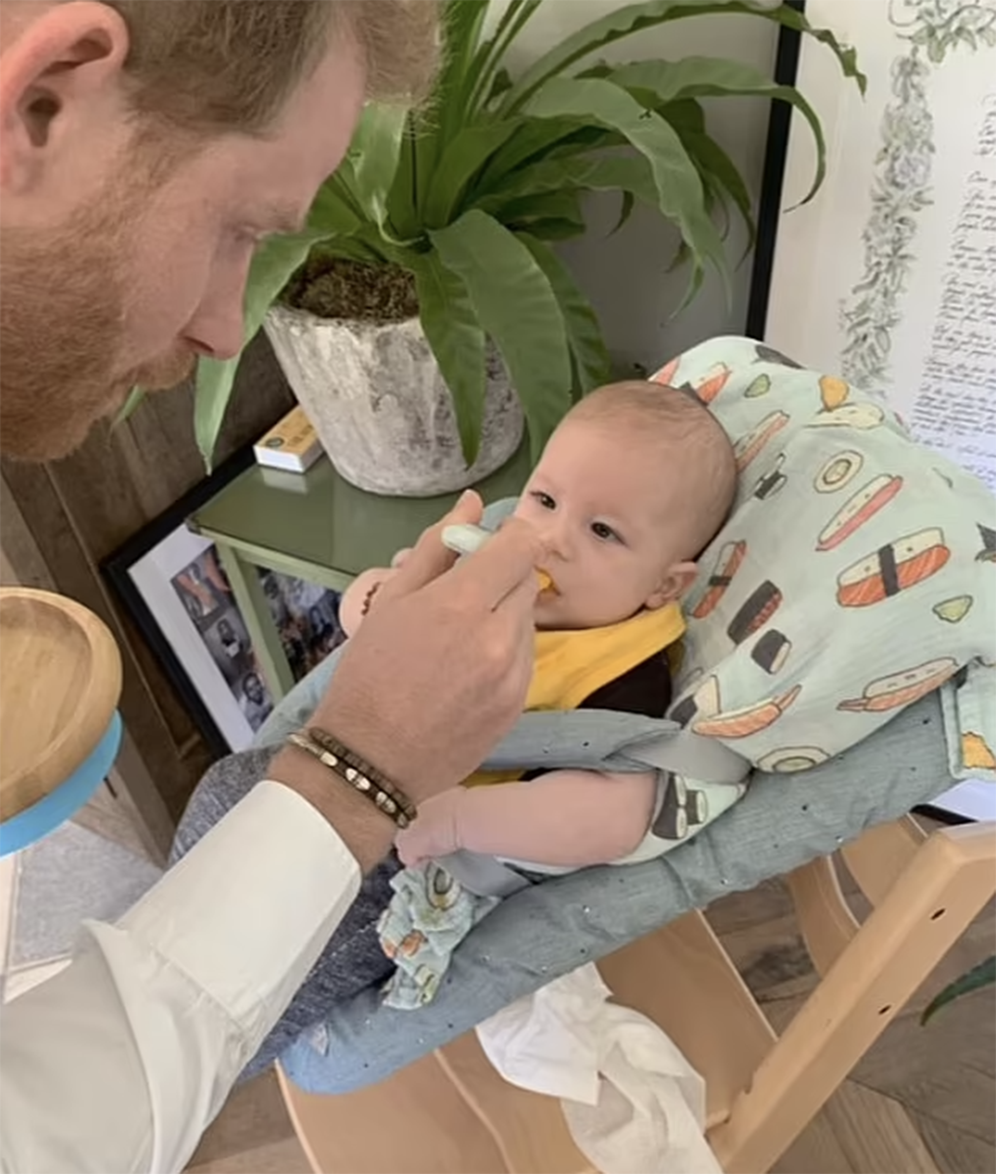 Archie being fed by his father.