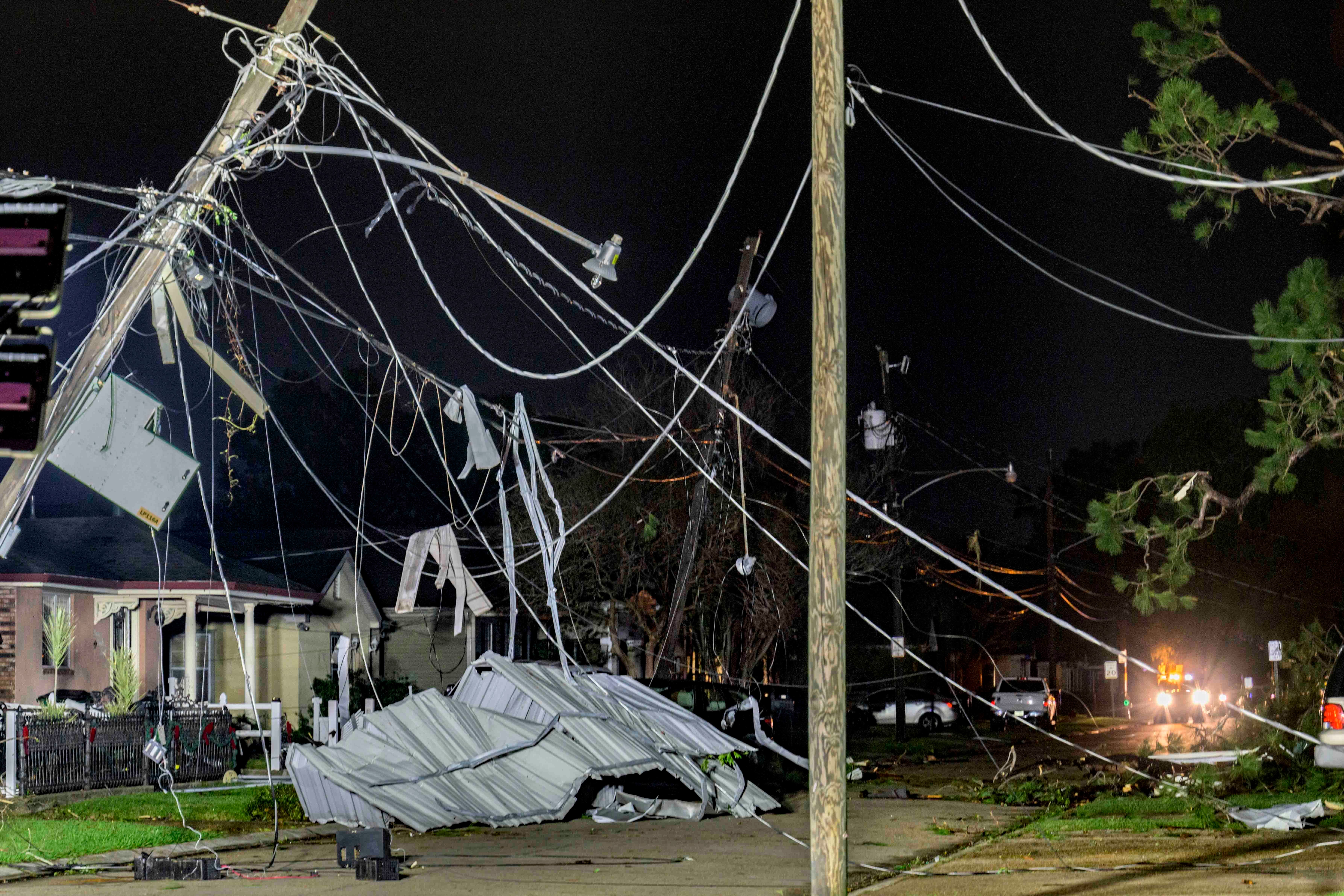 Power lines and metal roofing are seen in a tornado-damaged neighborhood in Gretna, Louisiana on Wednesday