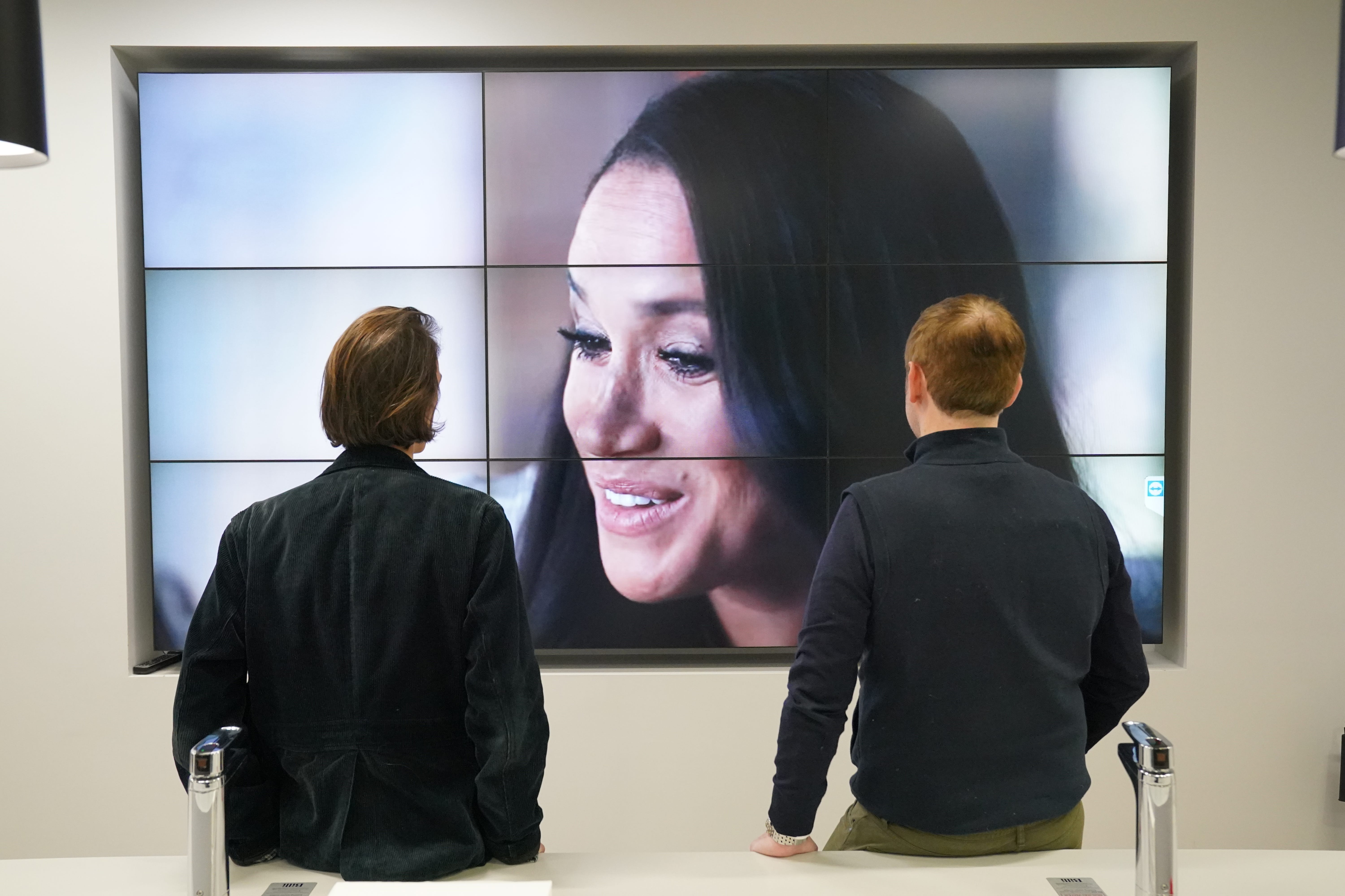 Office workers in London, watching the Duke and Duchess of Sussex’s controversial documentary being aired on Netflix (Jonathan Brady/PA)