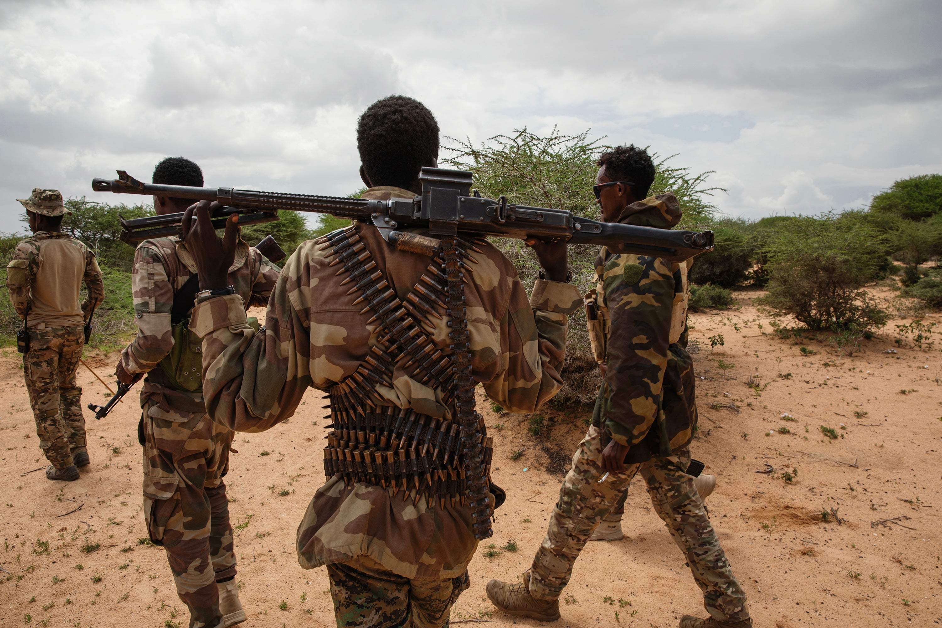 Soldiers walk outside the newly recaptured town of Masjid Ali Guduud