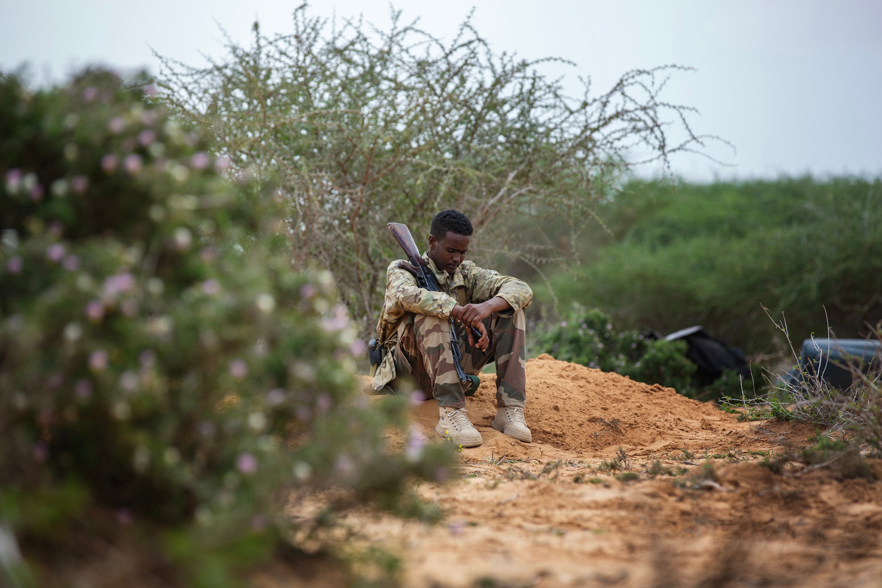 A soldier sits in a military camp in Masjid Ali Guduud