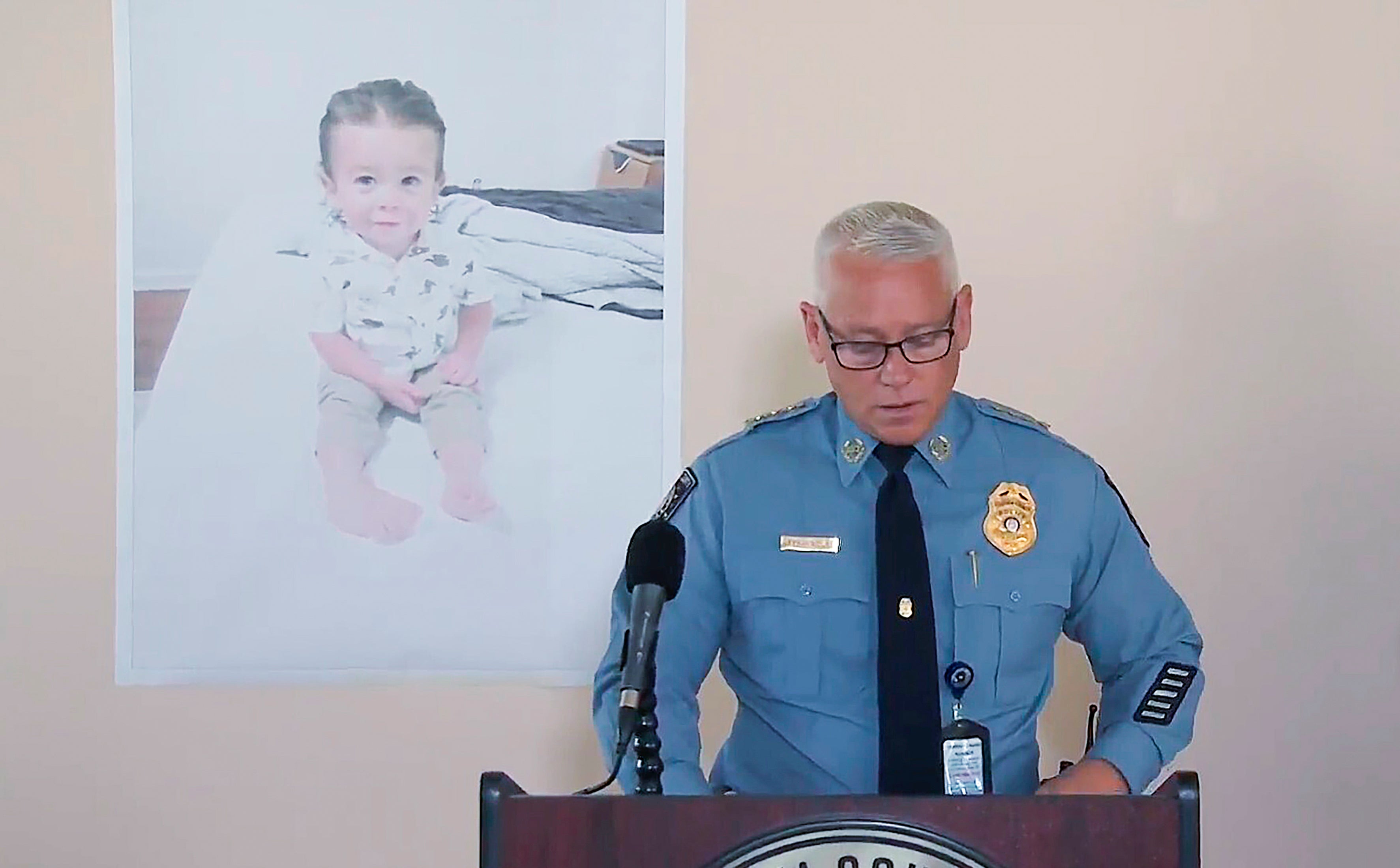 Chatham County, Georgia., Police Chief Jeff Hadley speaks to reporters as he stands in front of a large photo of missing toddler Quinton Simon at a police operations center being used in the search for the boy's remains just outside Savannah, Georgia.