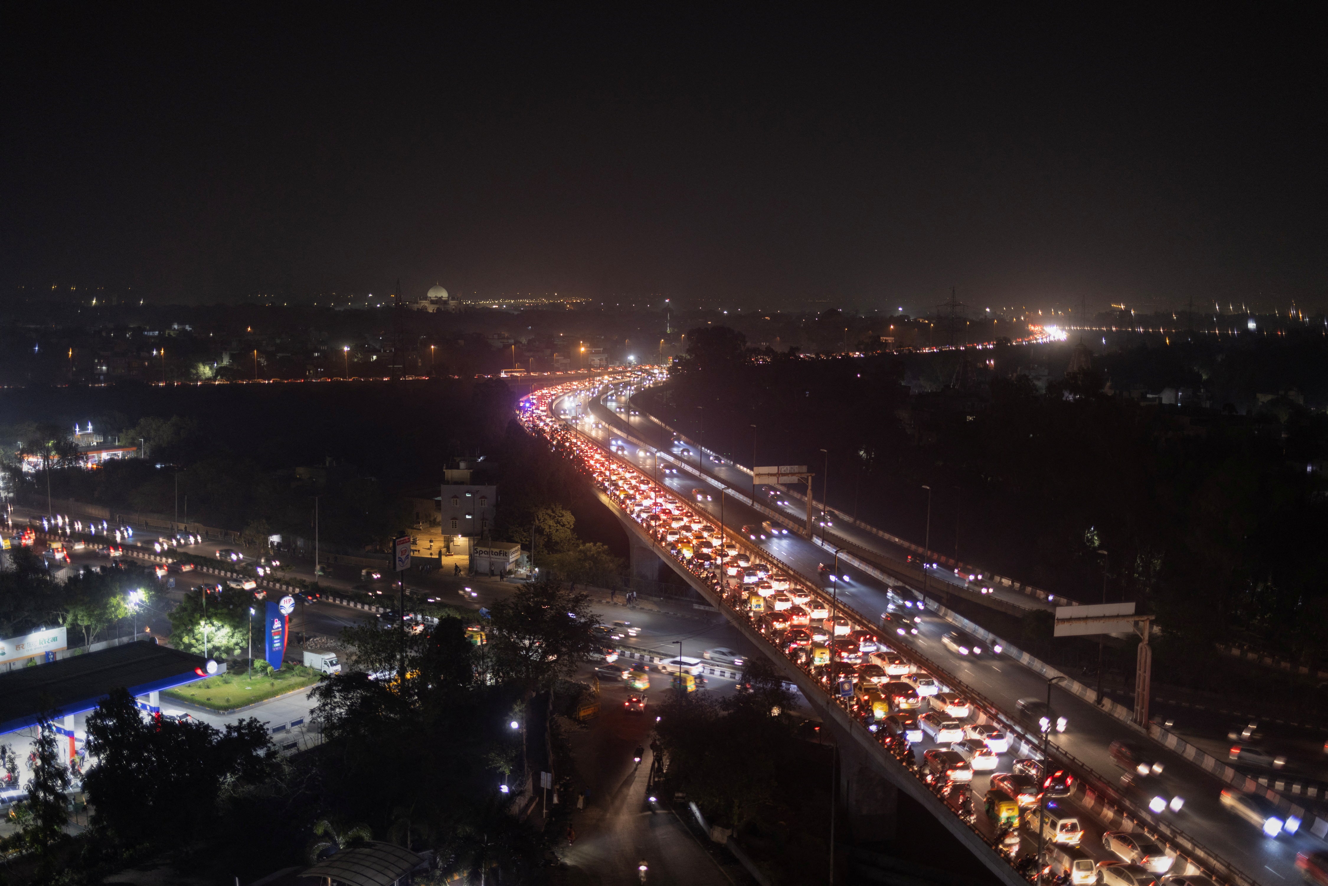 Traffic moves slowly amid smog on a flyover