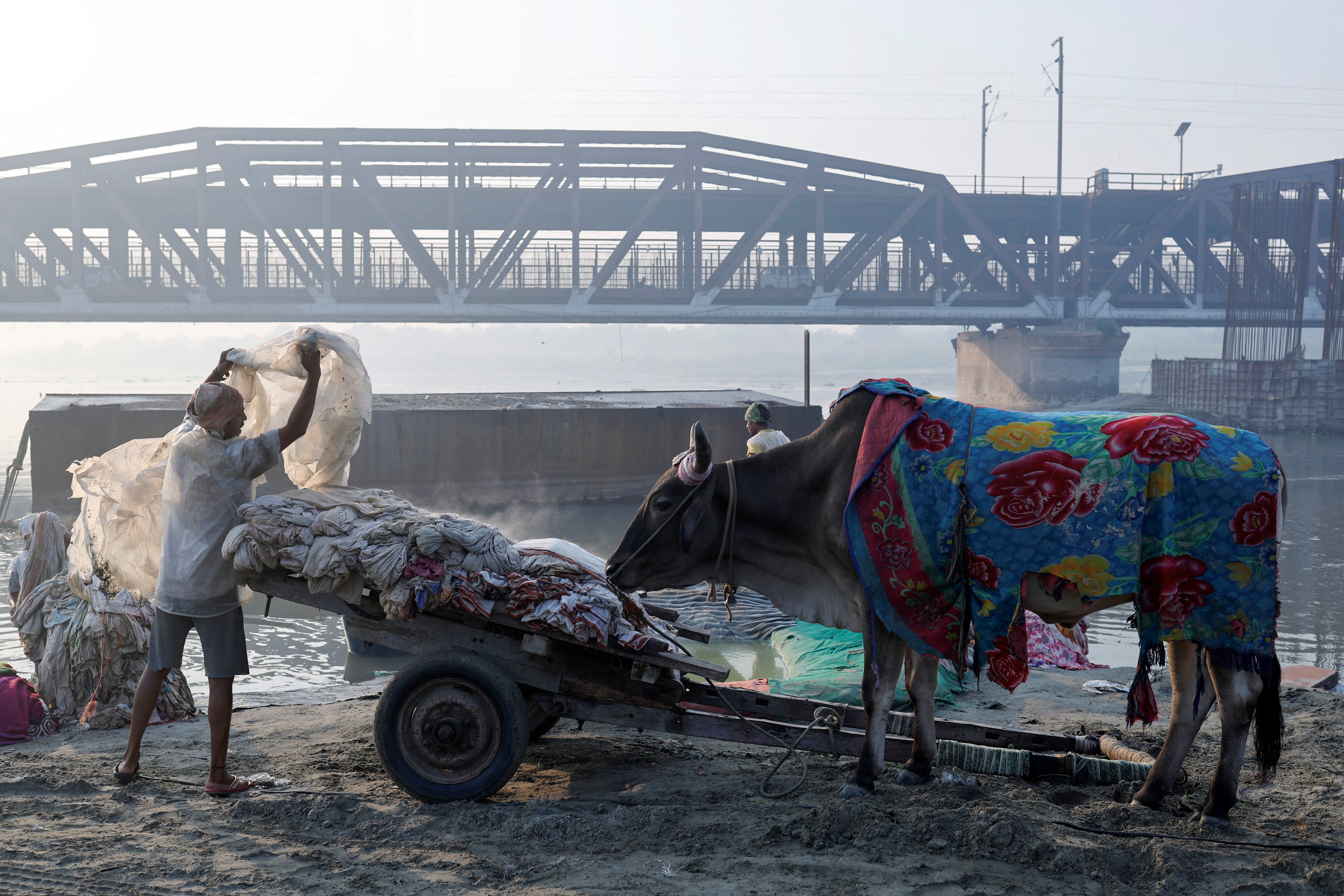 A washerman loads laundry onto a cart