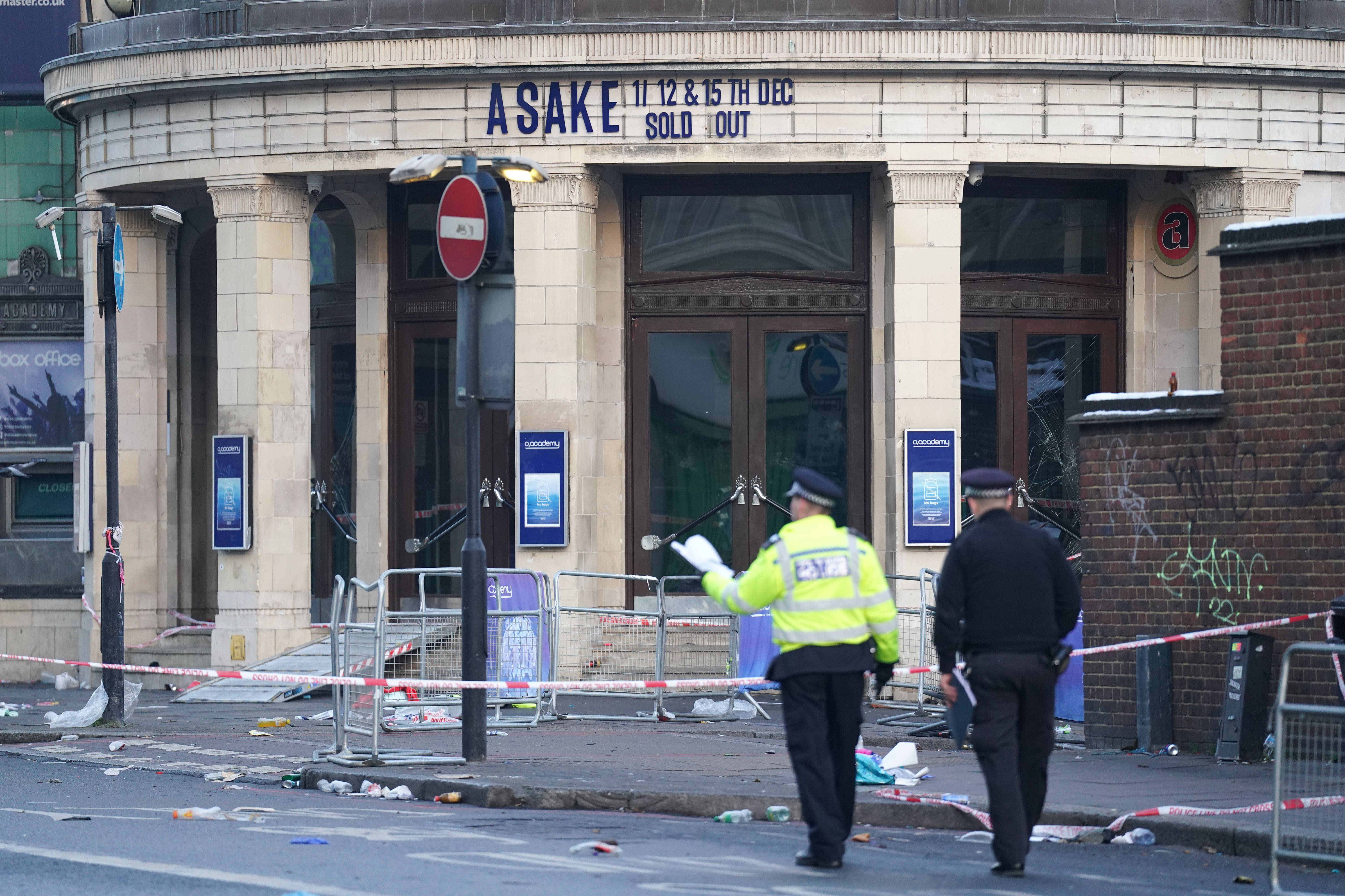 Police officers outside Brixton O2 Academy where they are investigating the circumstances which led to four people sustaining critical injuries in an apparent crush as a large crowd tried to force their way into the south London concert venue. Police were called to the venue at around 9.35pm on Thursday following reports that a large number of people were attempting to force entry during a performance by Nigerian Afrobeats singer-songwriter Asake. Picture date: Friday December 16, 2022.