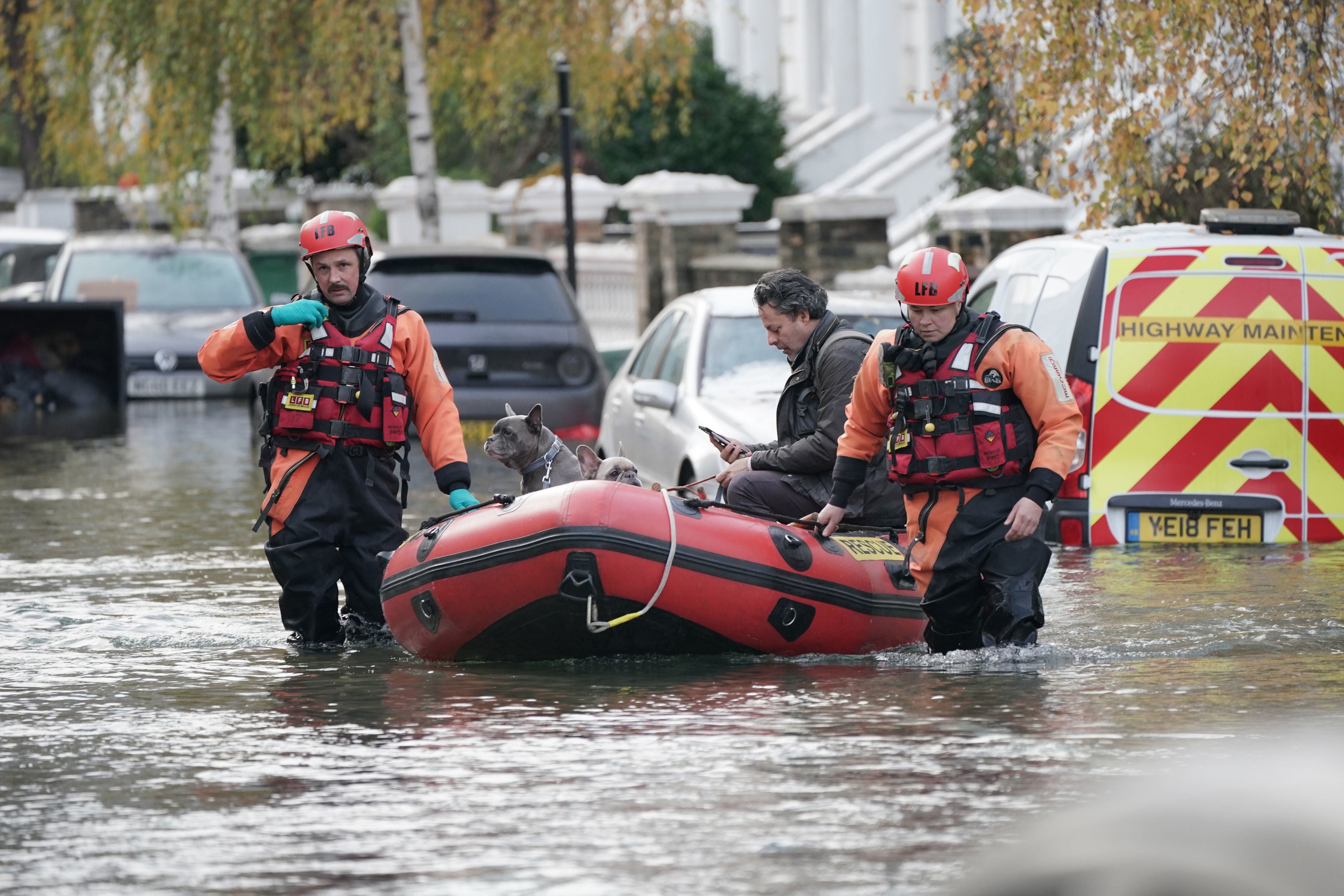 Emergency services rescue resident Stefano Calcagni and his dogs Batista and Pandora in Camden, north London