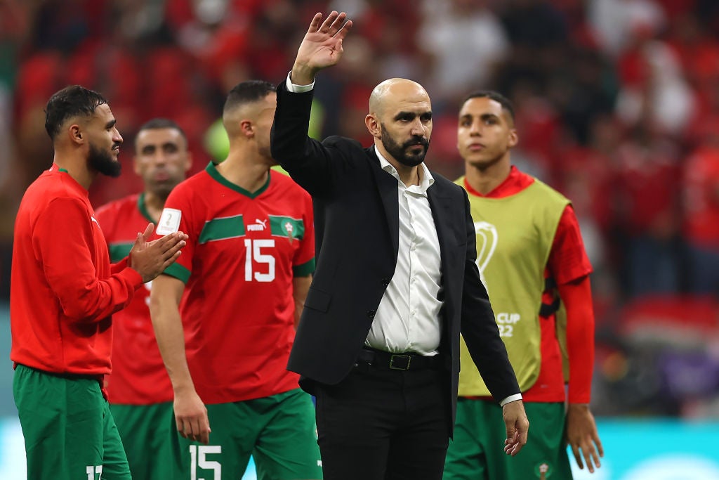 Walid Regragui, head coach of Morocco, applauds fans after his team loses to France in the semi-final