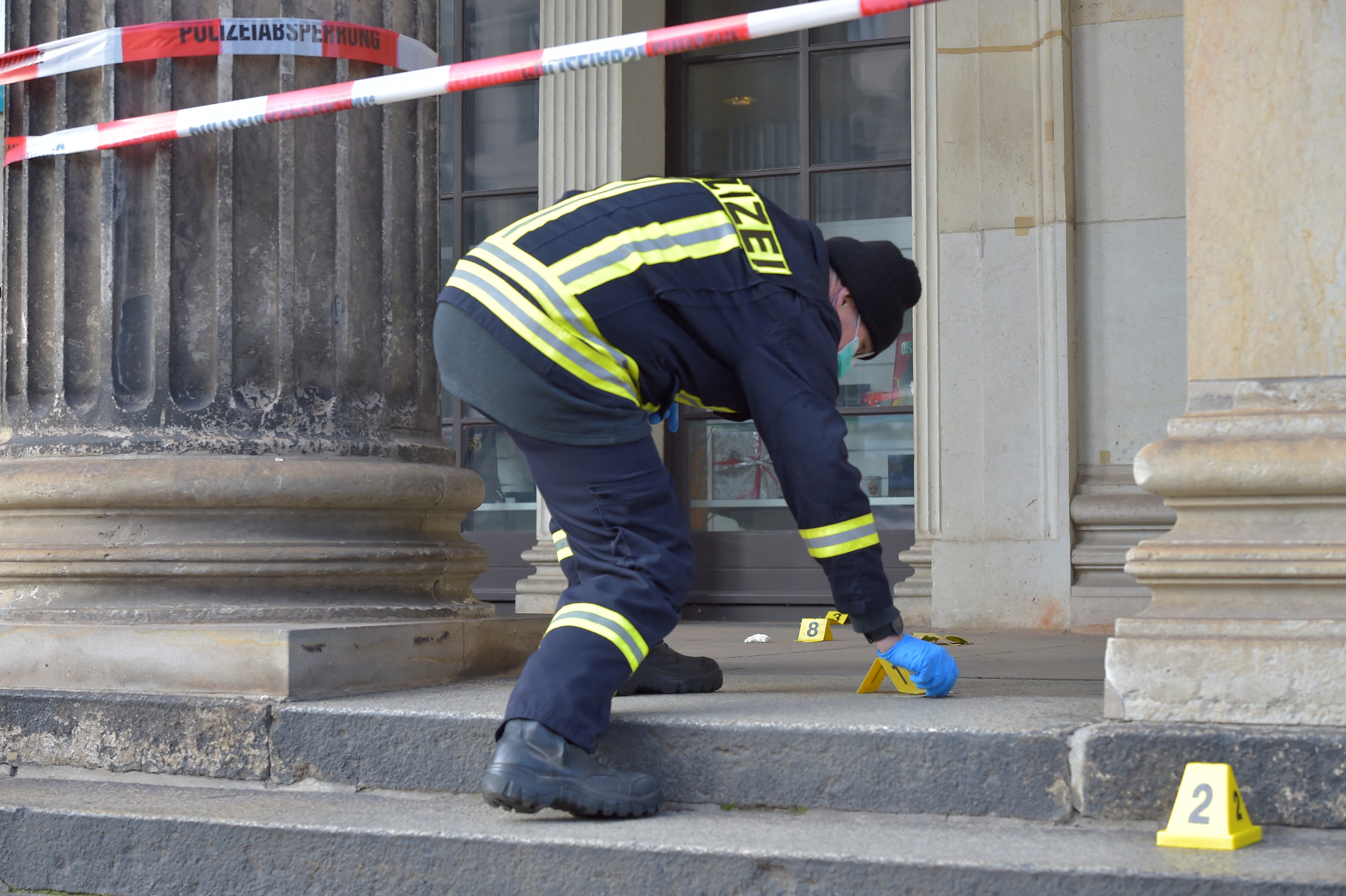 A police officer checks for evidence outside the museum on 25 November 2019