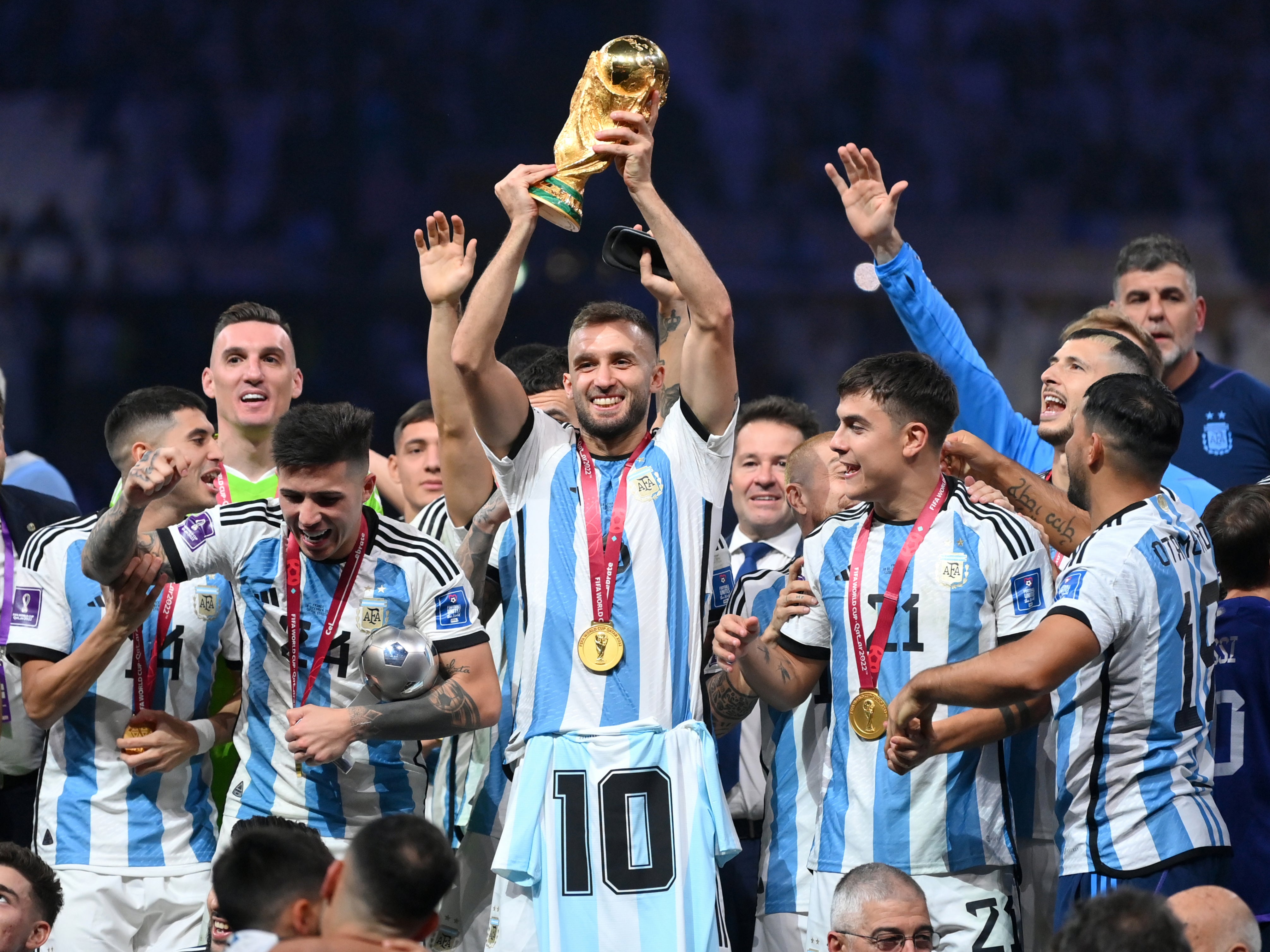 German Pezzella (centre) carries a shirt in honour of the late Diego Maradona