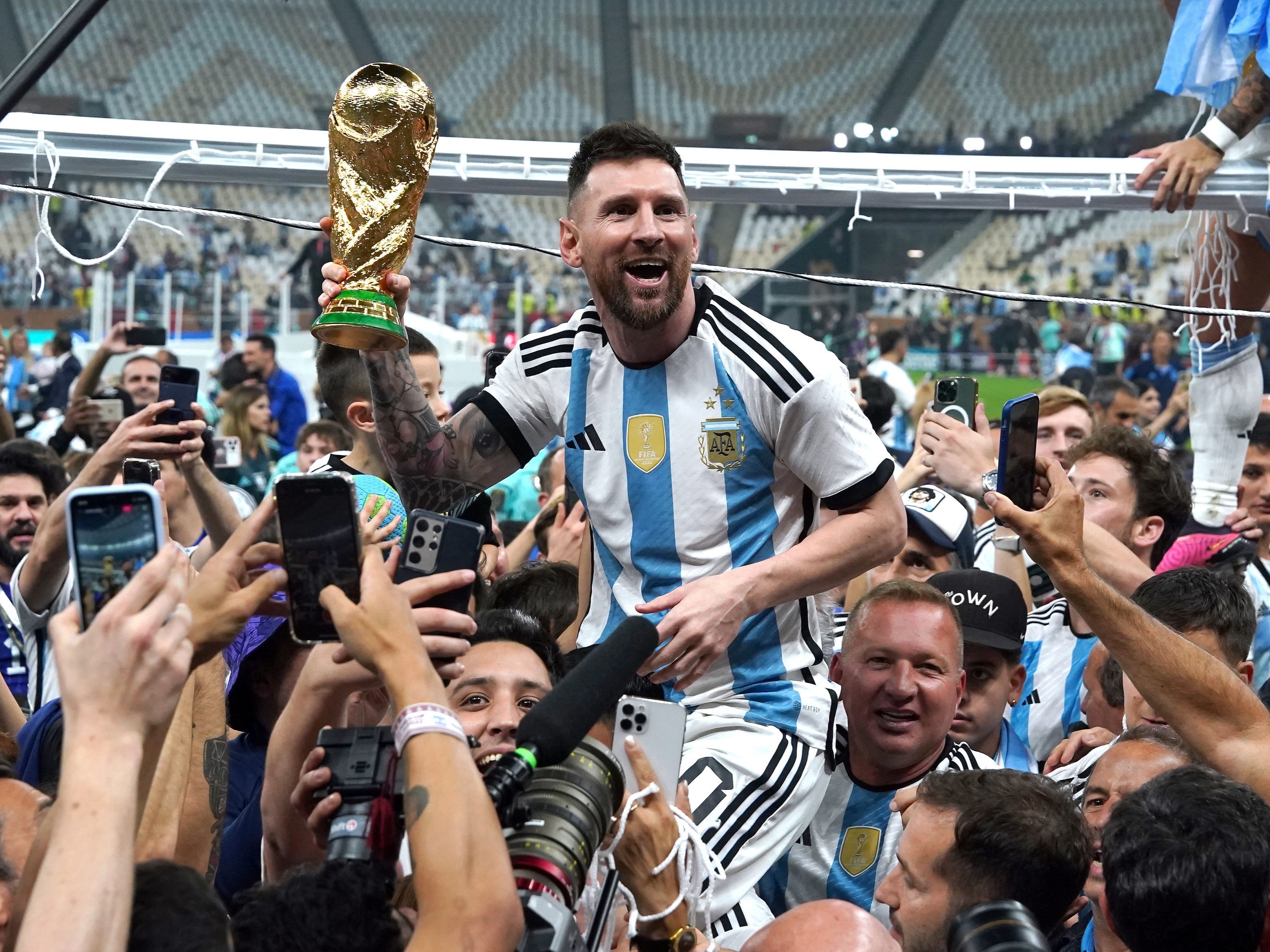 Messi holds the trophy on the pitch after Argentina’s win