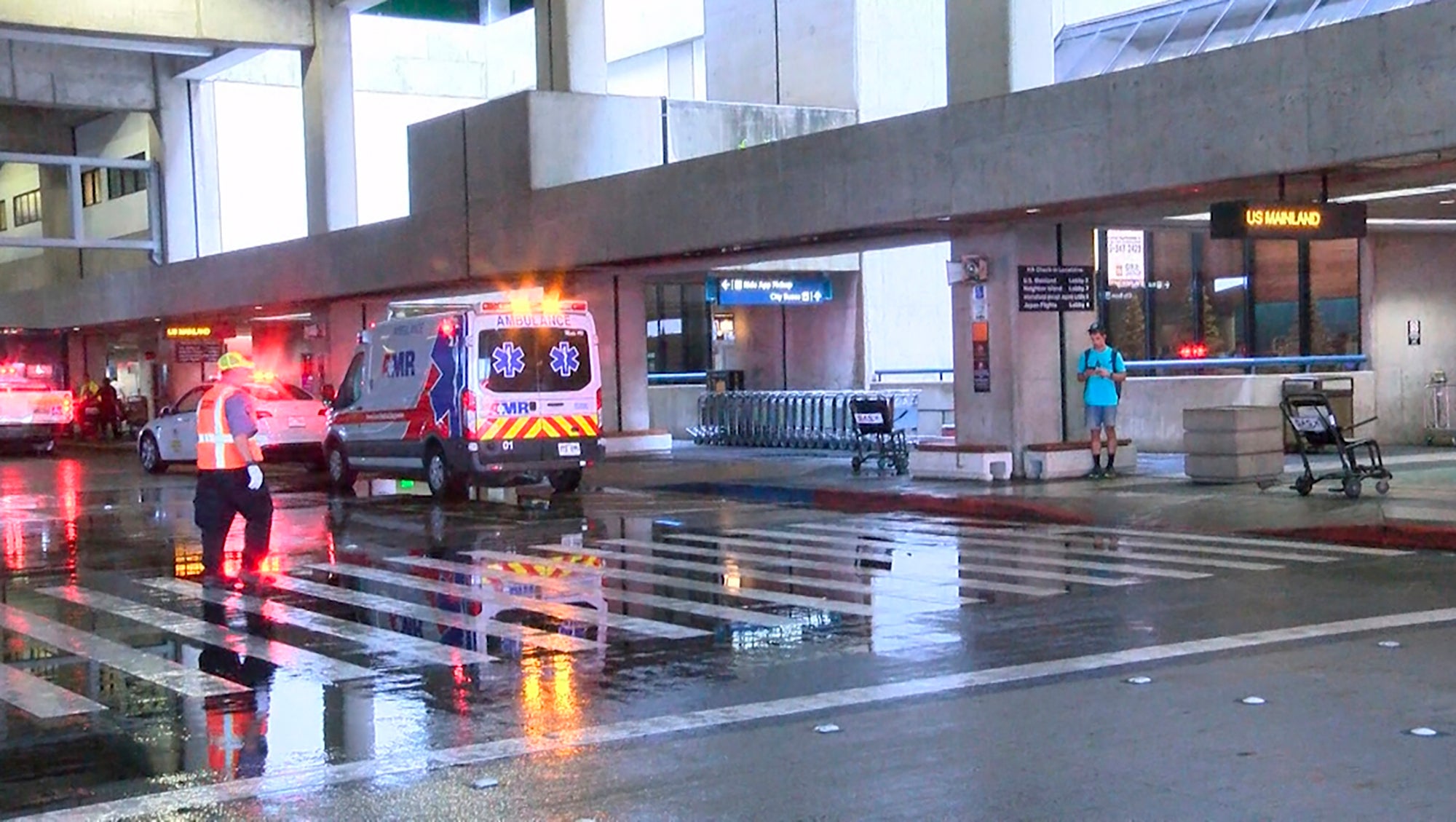 This image taken from video provided by Hawaii News Now shows the scene outside the international airport in Honolulu after nearly a dozen people were seriously injured when a flight to Hawaii hit severe turbulence on Sunday, 18 December2022