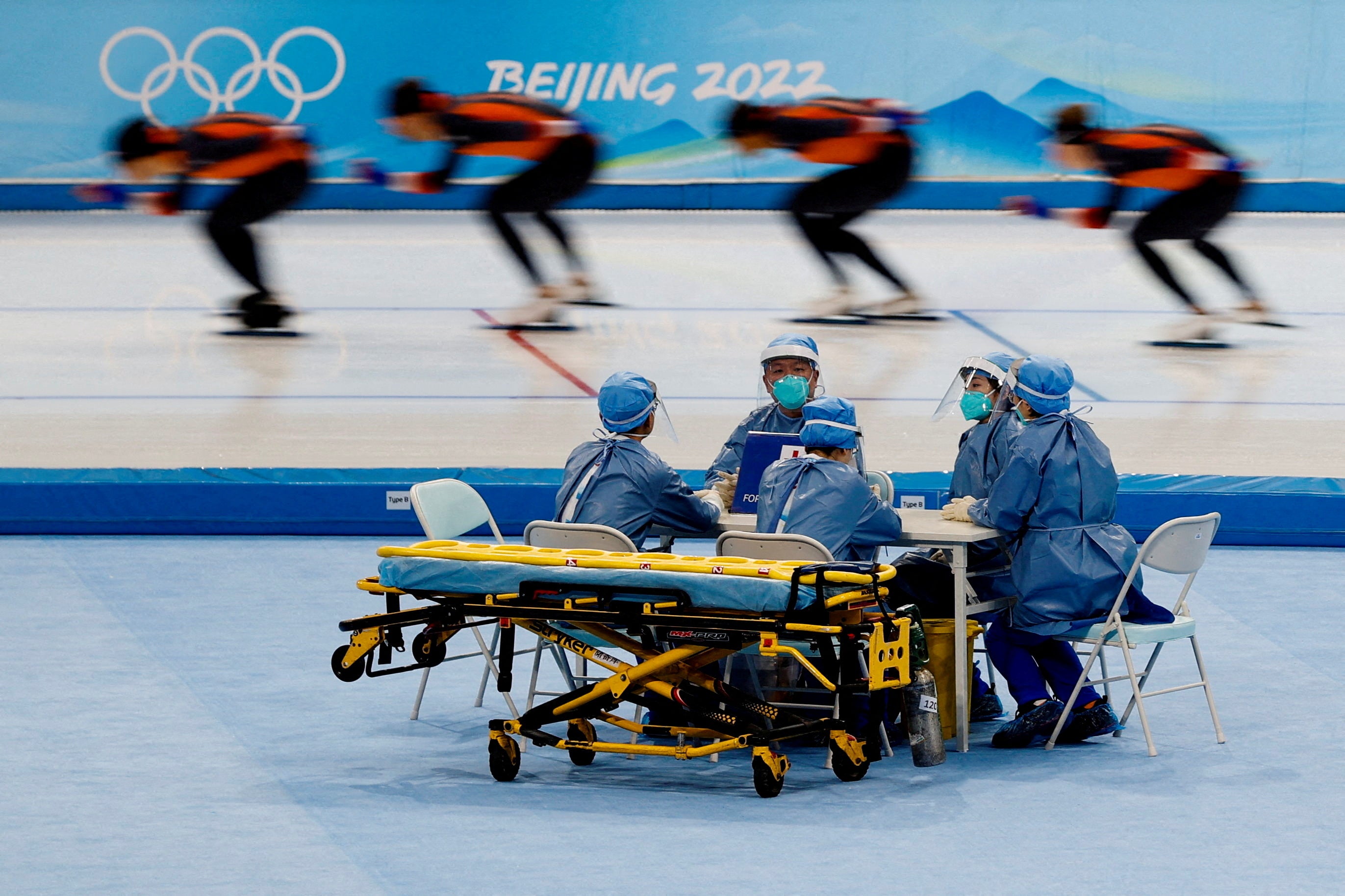 Medical staff in personal protective equipment at a speed skating training session at the Beijing 2022 Winter Olympics in China