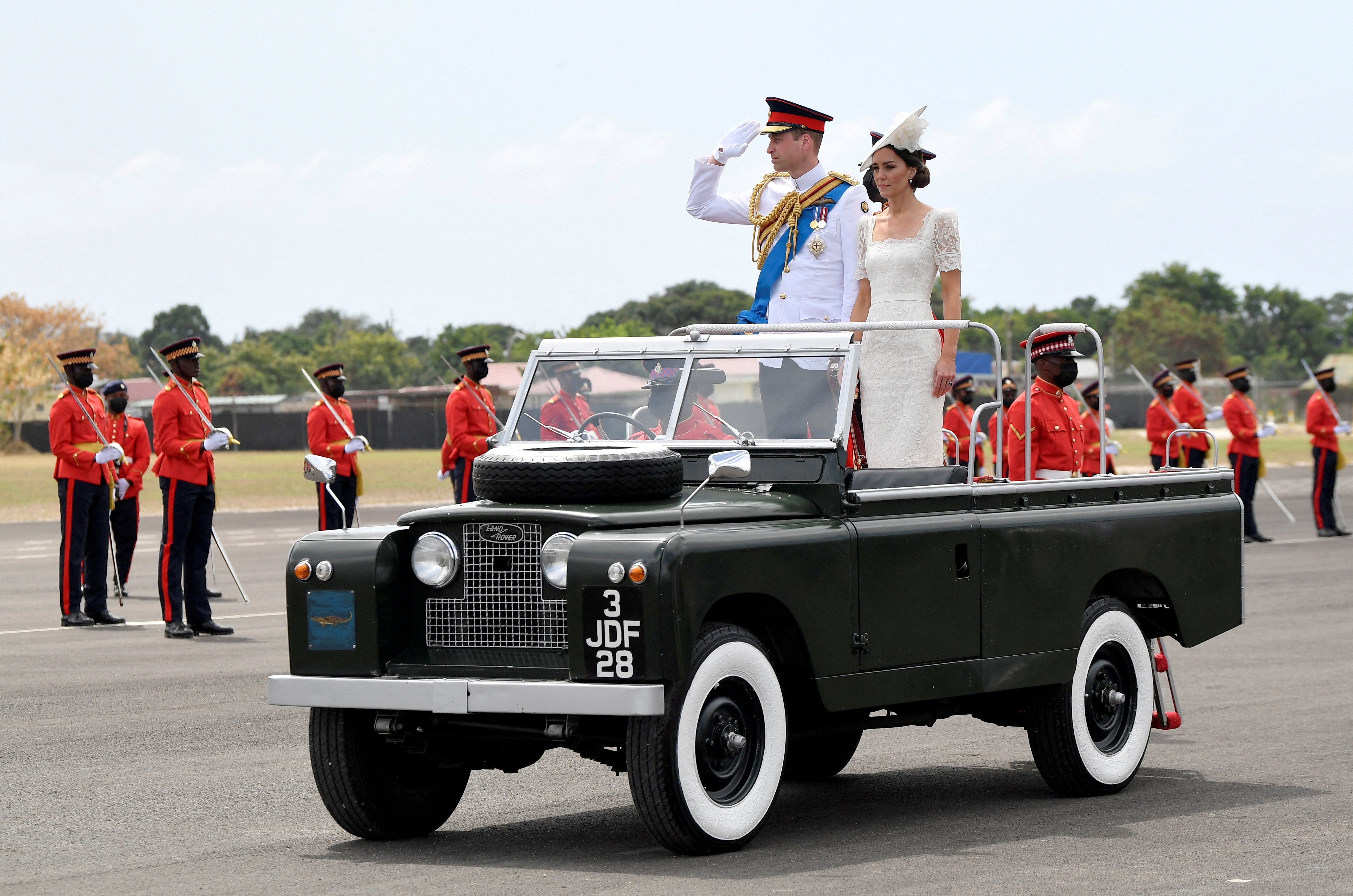 Prince William and Catherine, Duchess of Cambridge ride in a vintage Land Rover on the sixth day of their tour of the Caribbean in Kingston, Jamaica