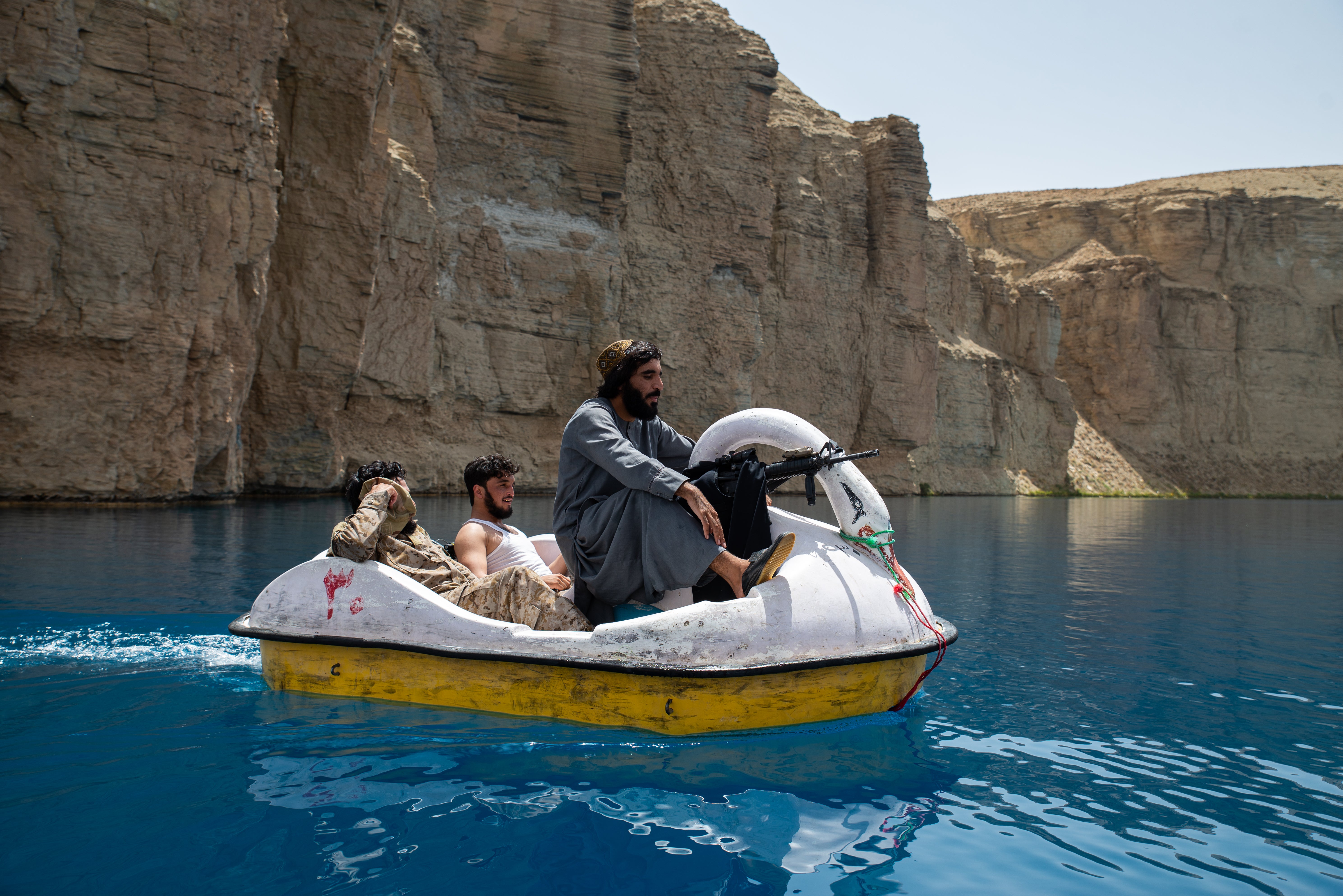 Taliban members paddle in a boat in Band-e Amir national park, a popular week-end destination in Band-e Amir, Bamyan province of Afghanistan