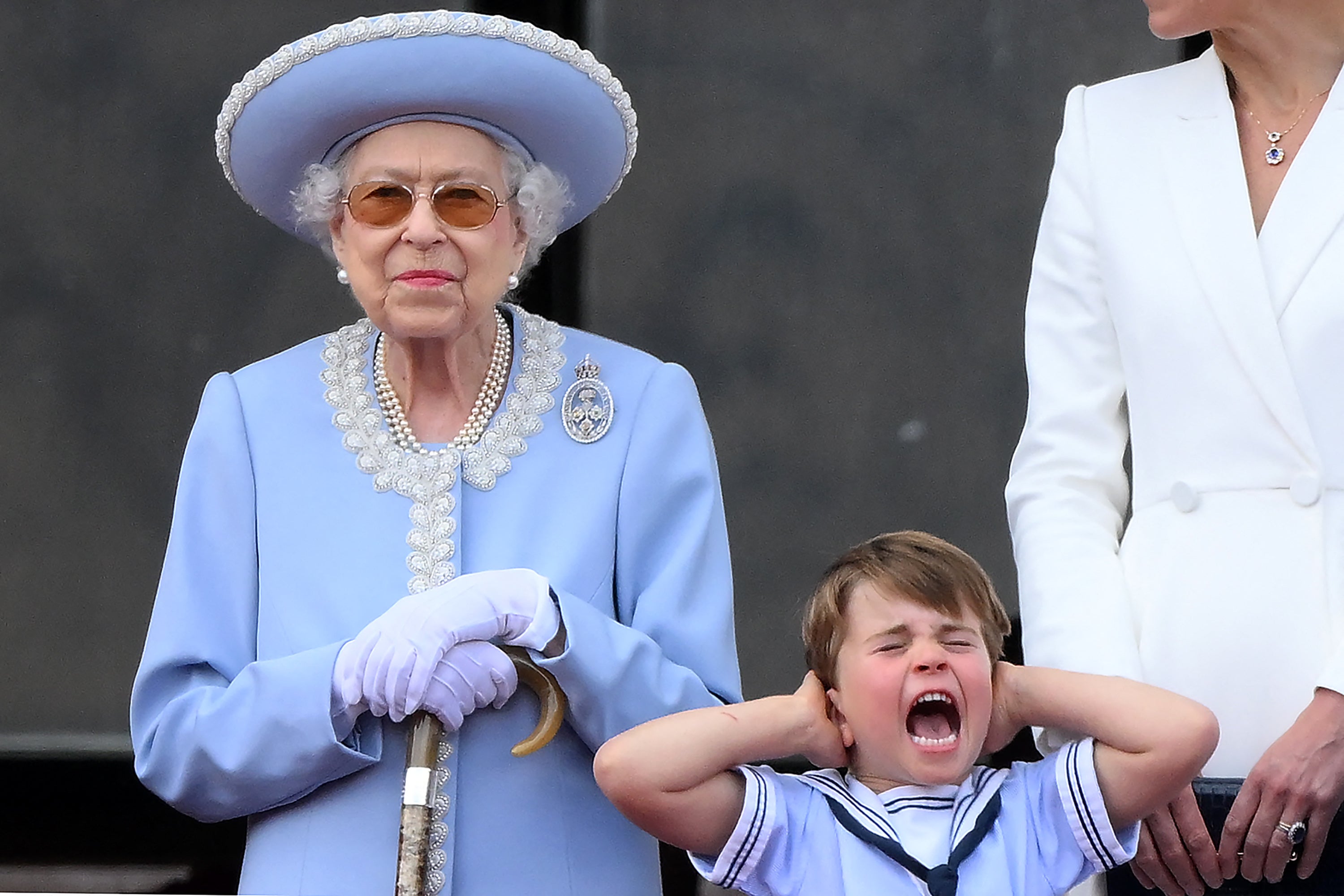 Prince Louis holds his ears as he stands next to Queen Elizabeth II to watch a special flypast, from Buckingham Palace balcony, as part of the platinum jubilee celebrations