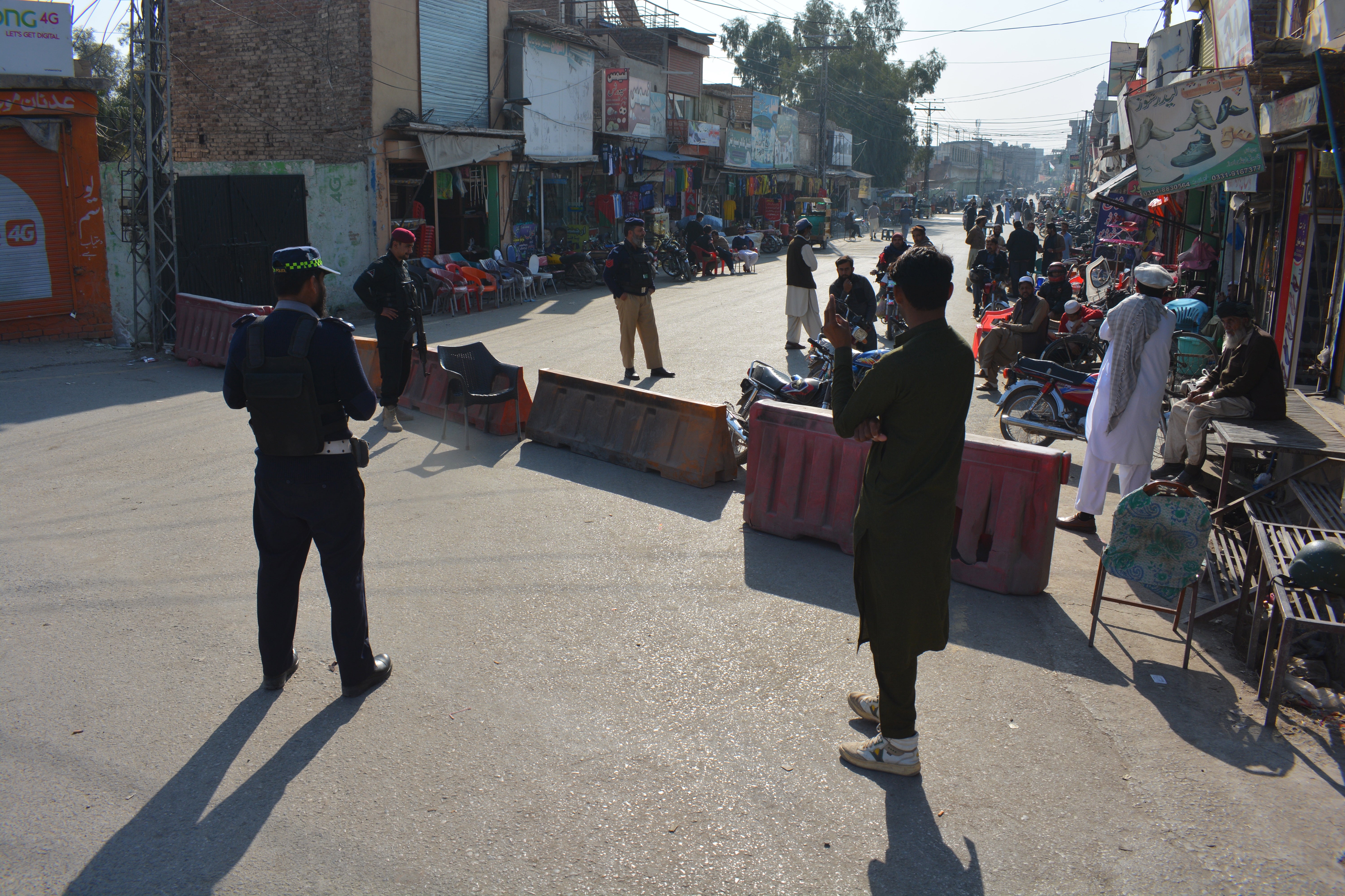 Pakistani security officials stand guard outside the entrance to Bannu Cantt area