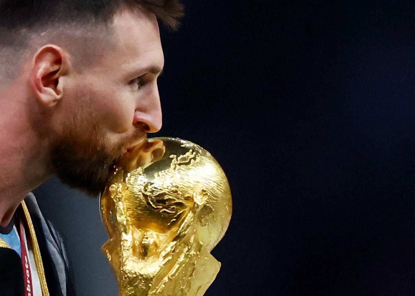 Argentina’s Lionel Messi kisses the trophy as he celebrates winning the World Cup