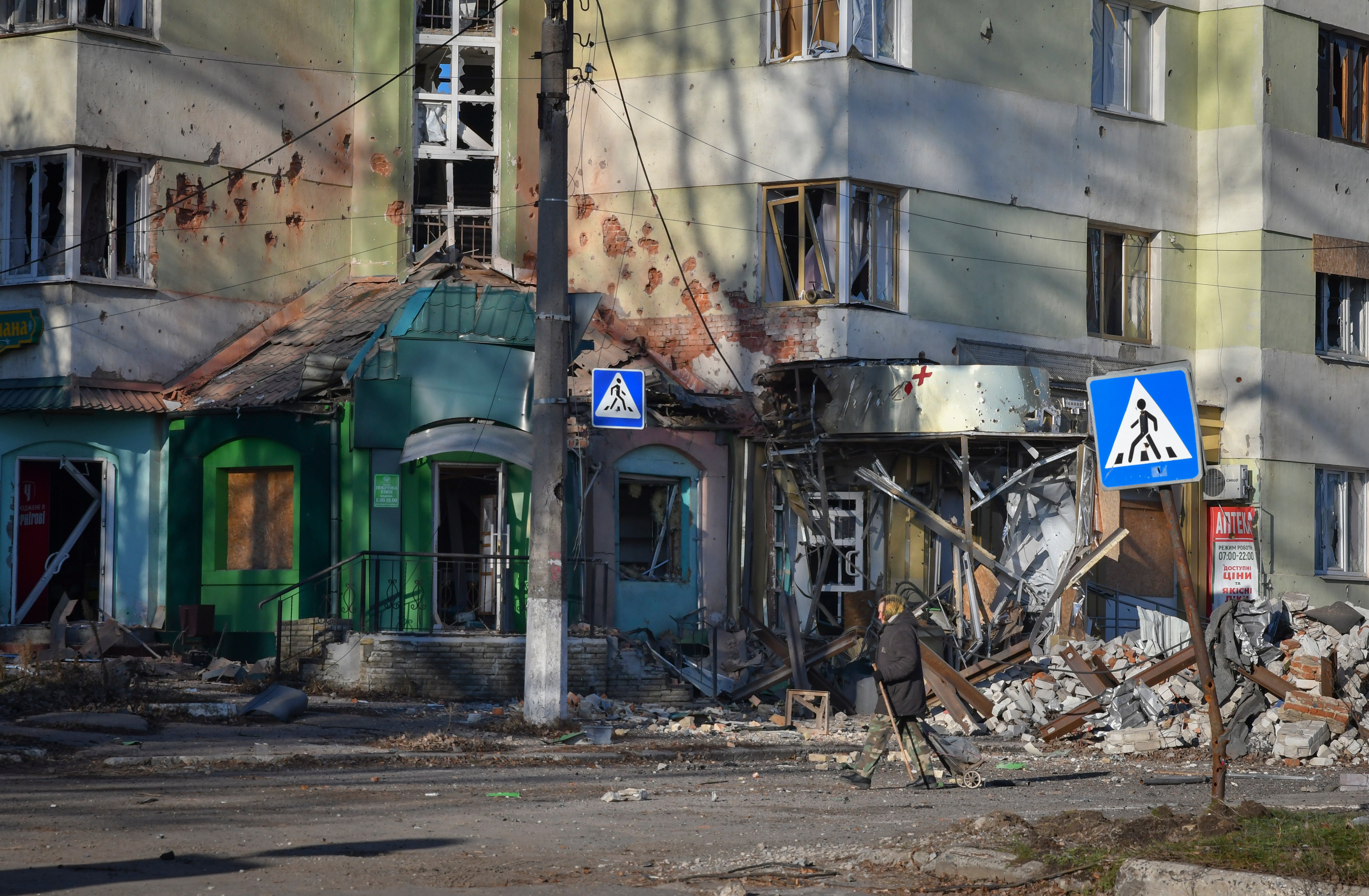 A local resident walks along a street in the areaof the heaviest battles with the Russian invaders in Bakhmut