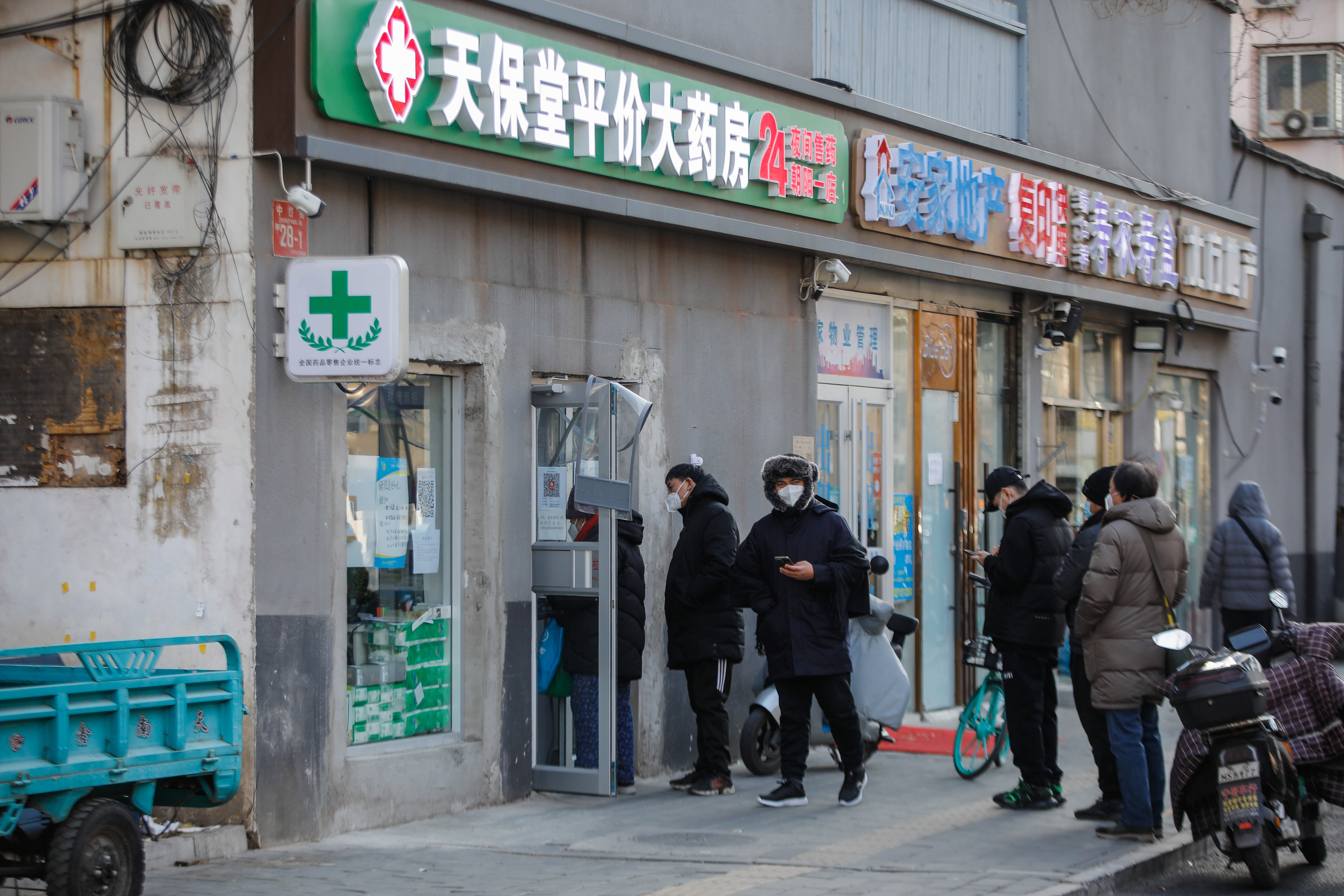 Chinese people queue for medication in Beijing on Wednesday amid the Covid surge