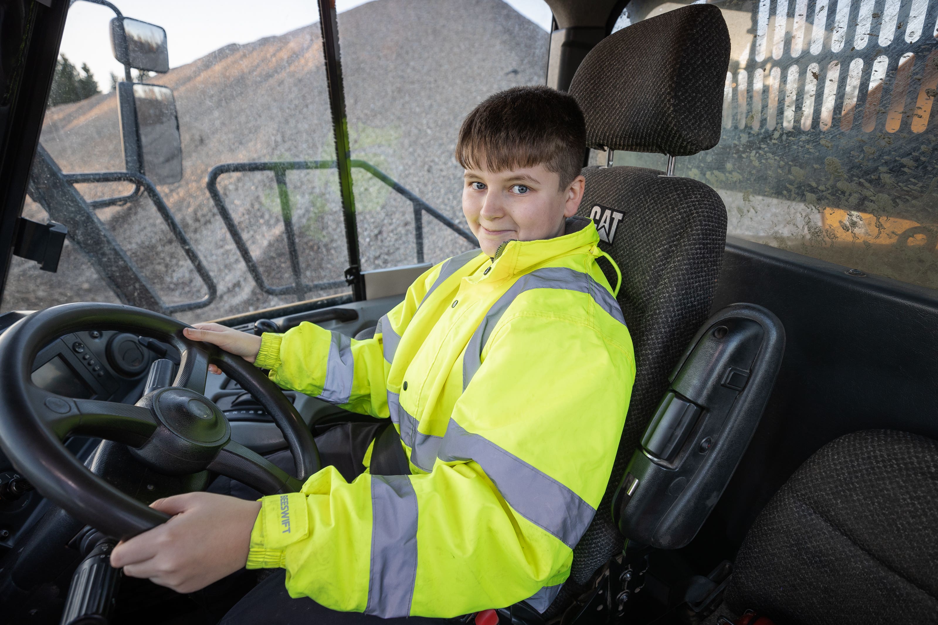 Jay Currie at the wheel of a dump truck (Paul Campbell/PA)