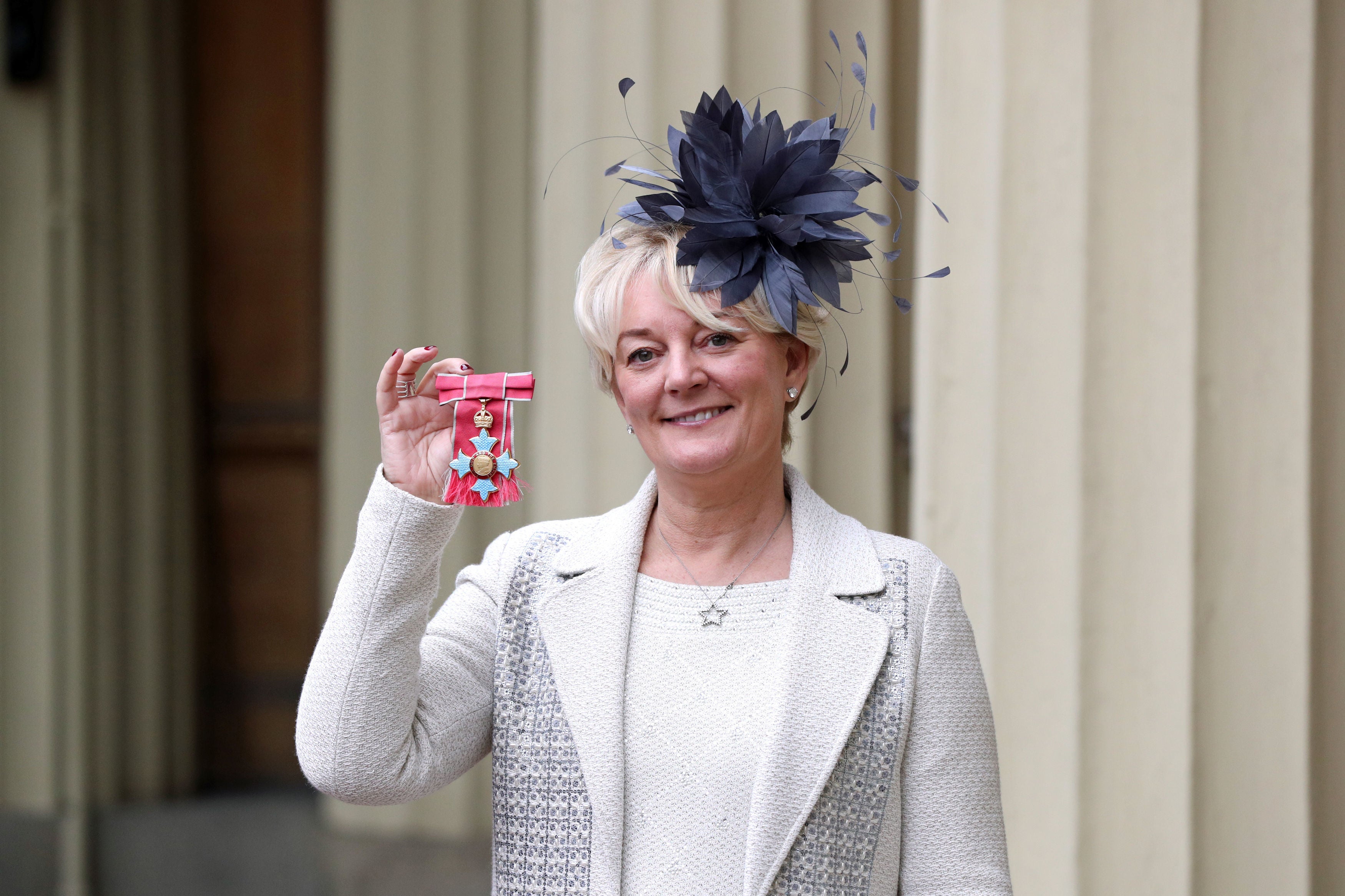 Entrepreneur Jo Malone poses after being made a CBE at an investiture ceremony at Buckingham Palace on November 16, 2018