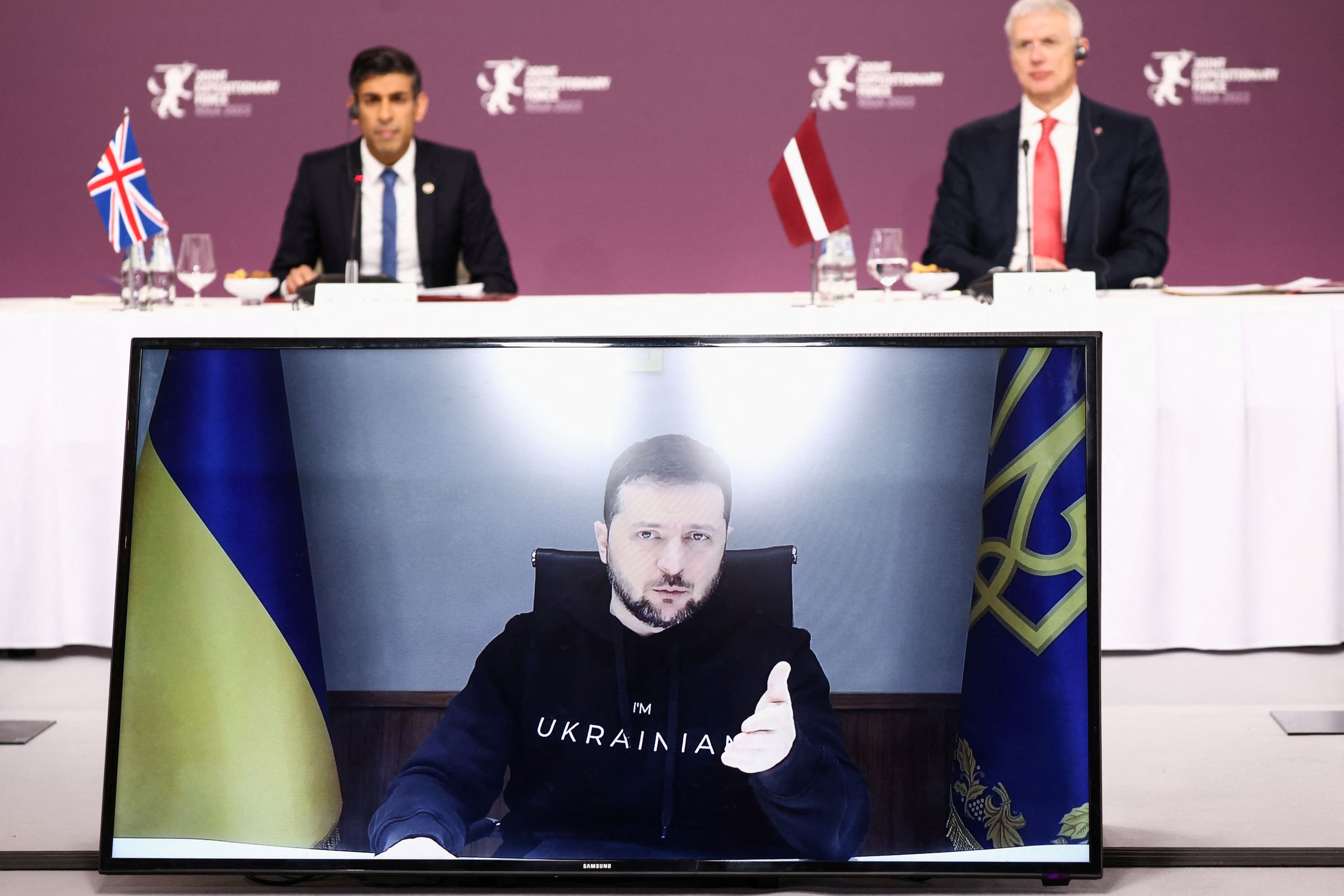 Ukrainian President Volodymyr Zelensky speaks via video link as Latvian Prime Minister Krisjanis Karins and Prime Minister Rishi Sunak listen during the Joint Expeditionary Force (JEF) Summit in Riga, Latvia (Henry Nicholls/PA)