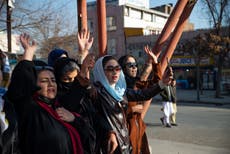 Afghan Taliban use barbed wire fence and armed guards to keep women out of universities