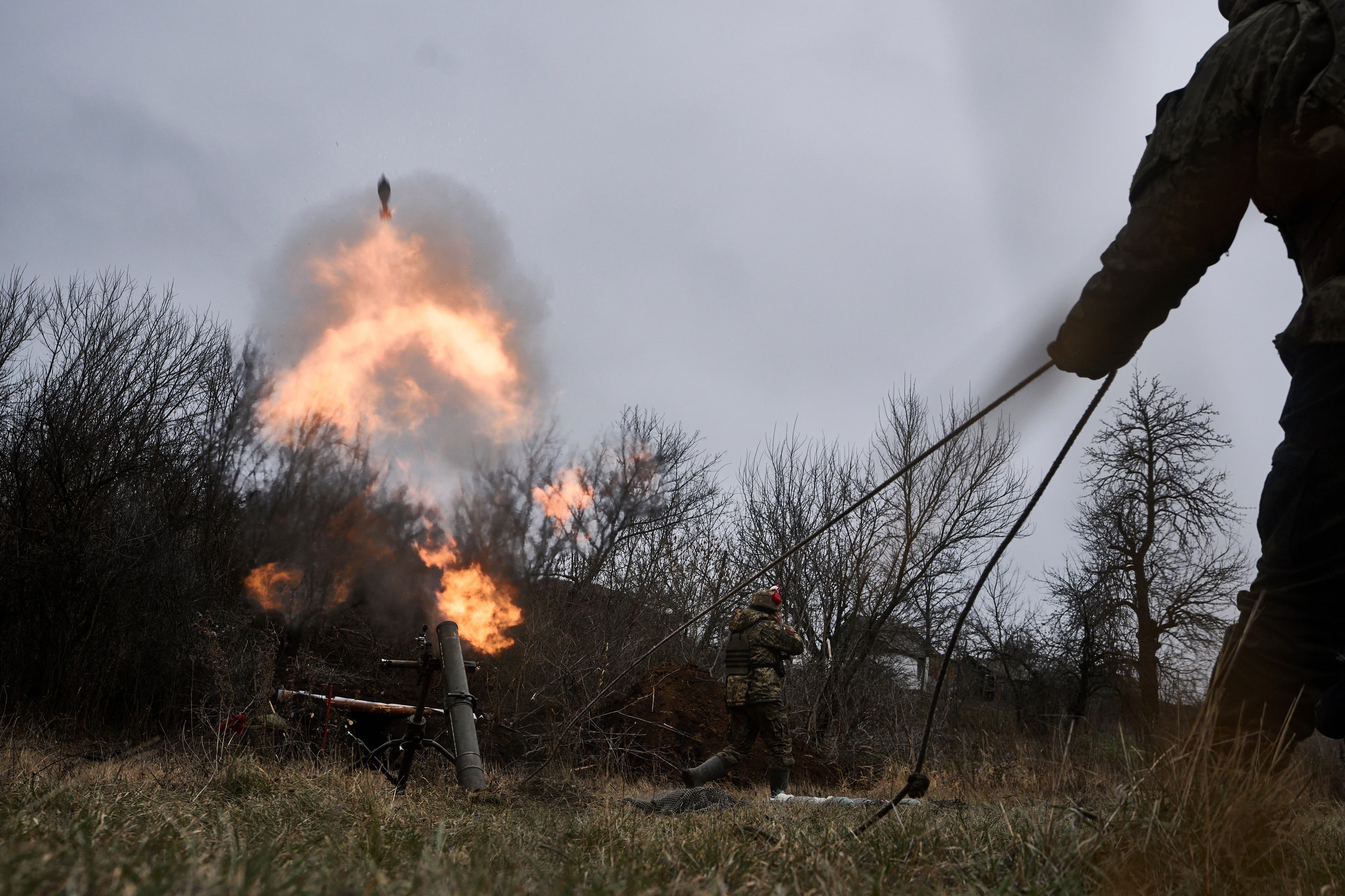 Ukrainian soldiers fire a mortar towards Russian positions, near Bakhmut on Thursday