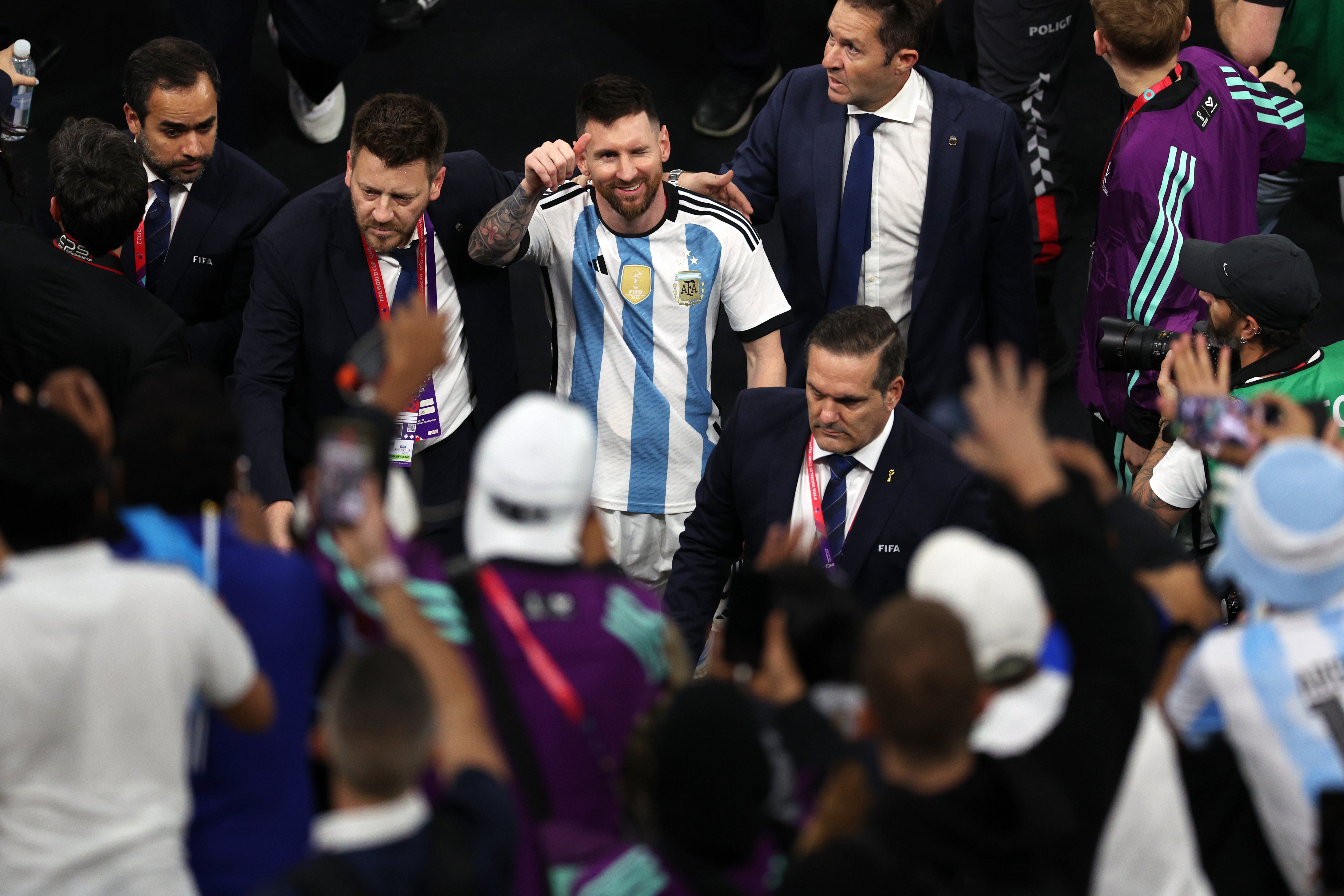 Messi walks off the pitch with protection after World Cup win